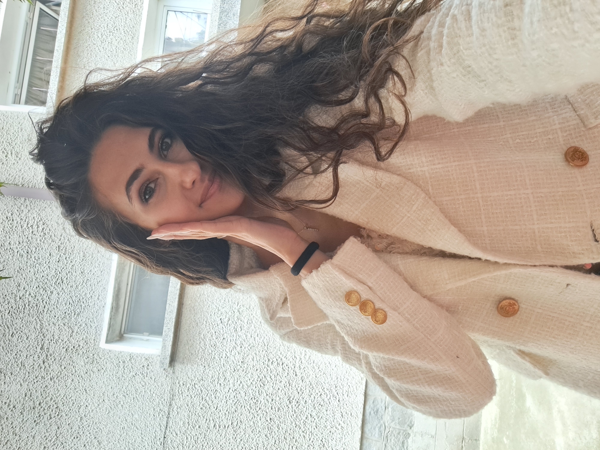Woman takes selfies in cream blazer in Negovan