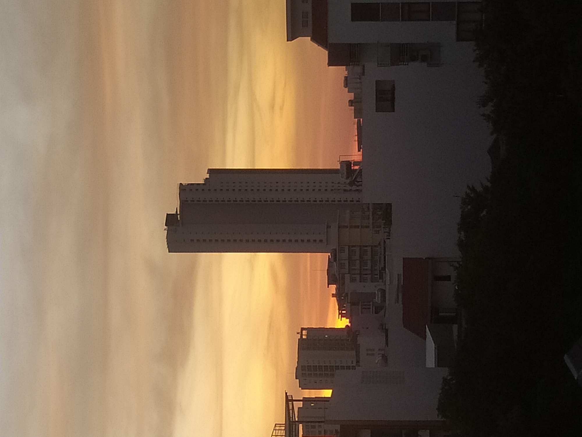 City skyline glowing through a golden-hour sunset