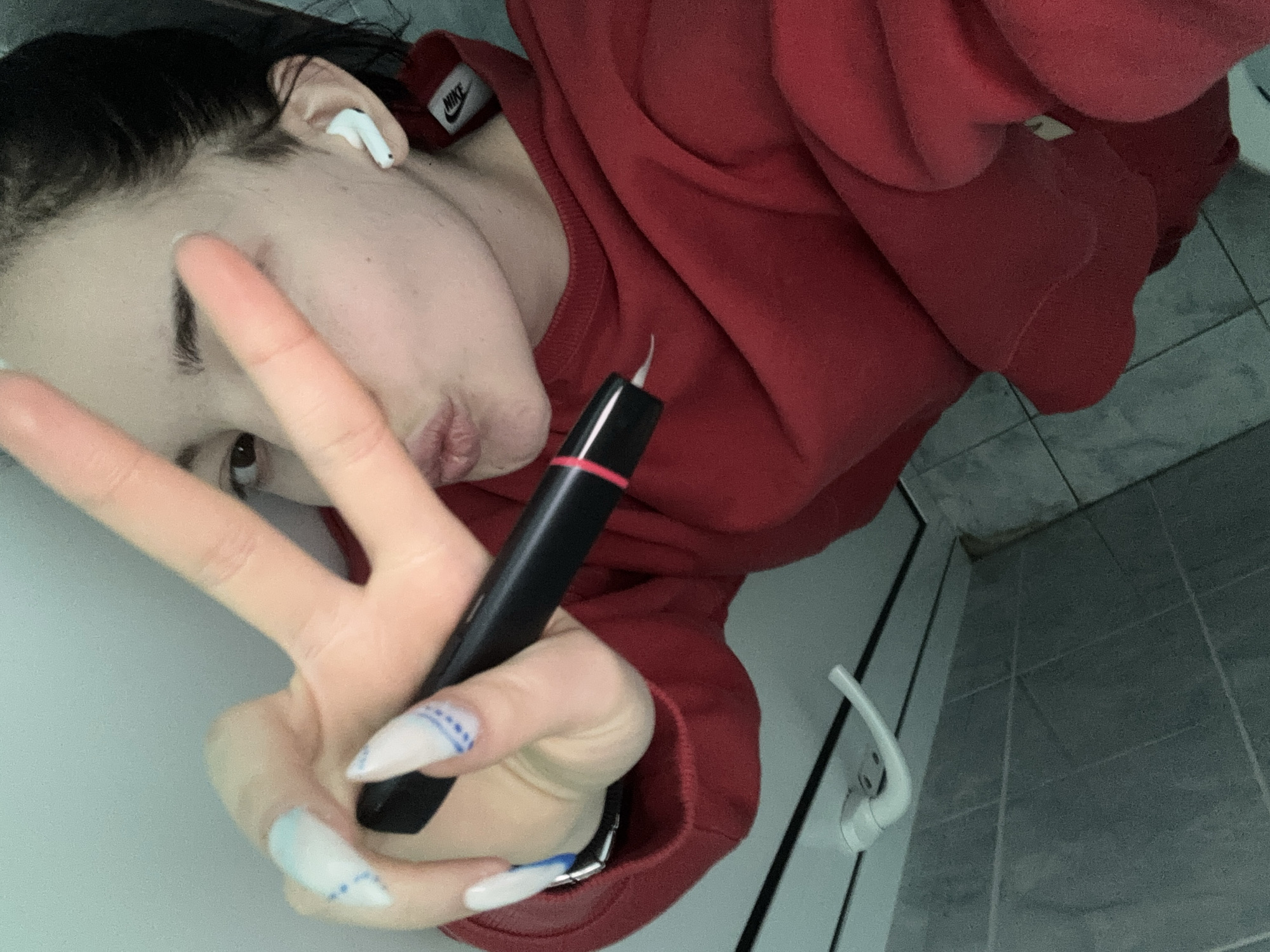Woman with Nike sweatshirt uses electronic device in Sofia