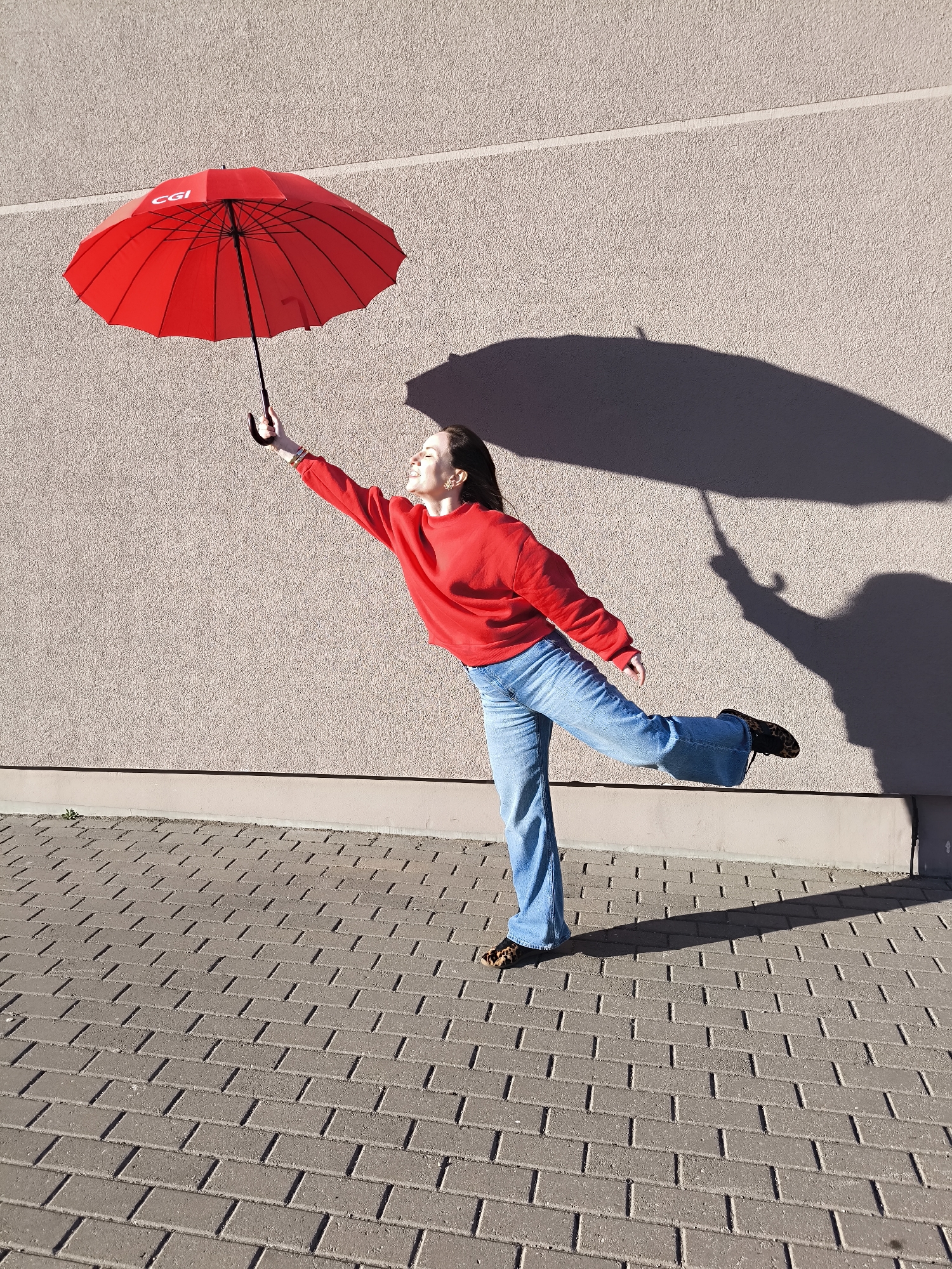 Woman poses with CGI umbrella in Riga street scene