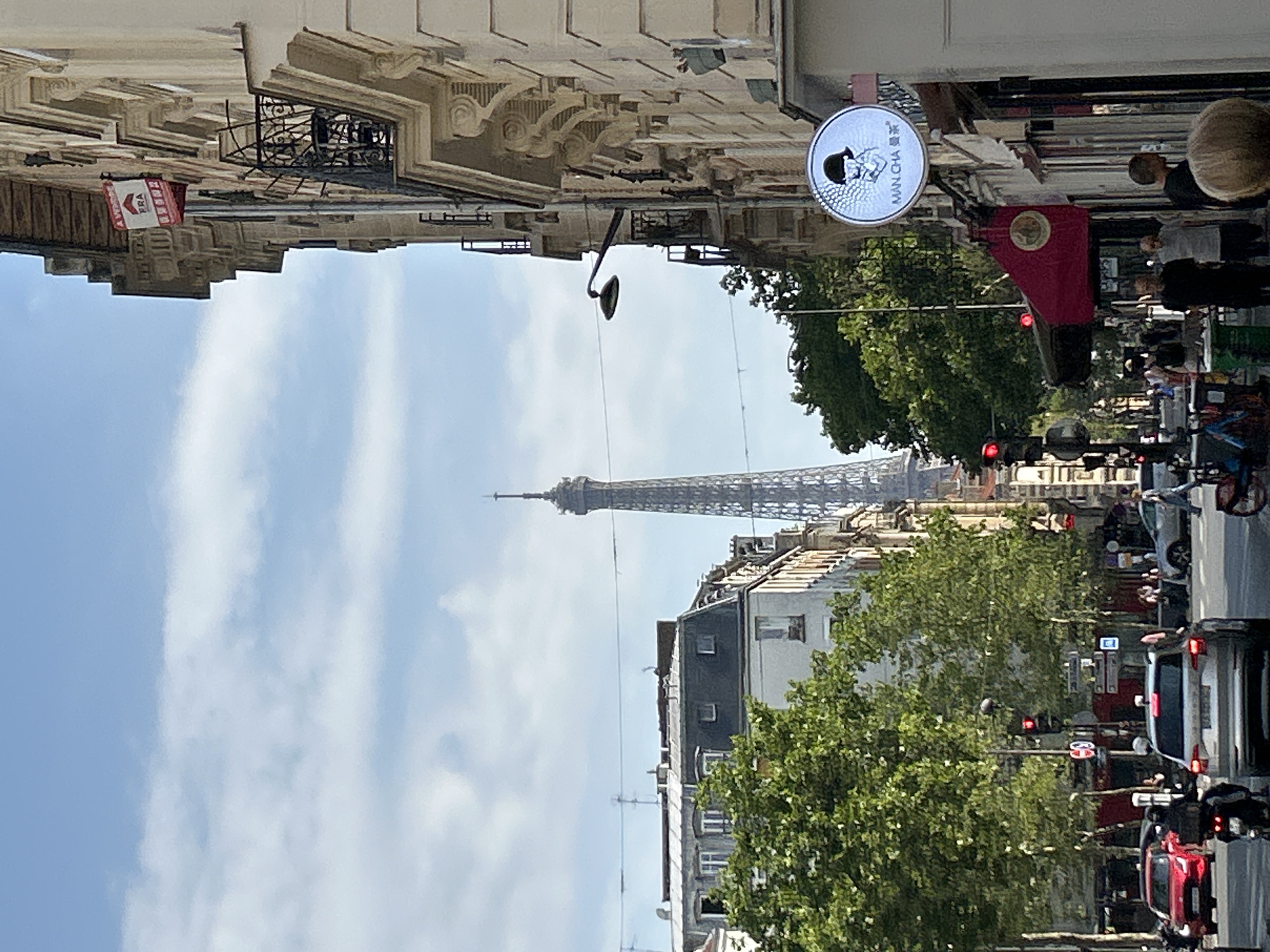 Street-level view of Paris with Eiffel Tower in the background