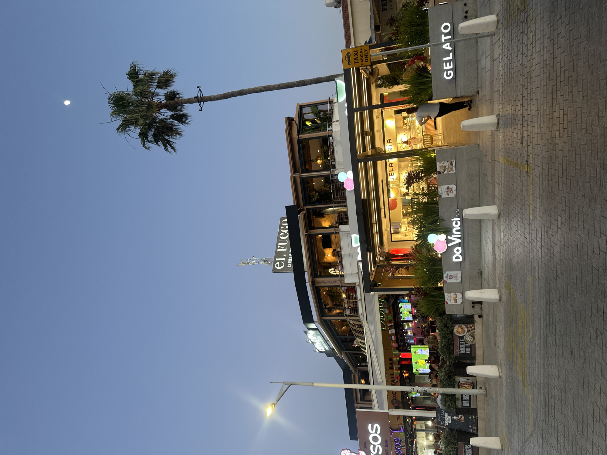 Peyia's main strip comes alive at dusk on a June evening