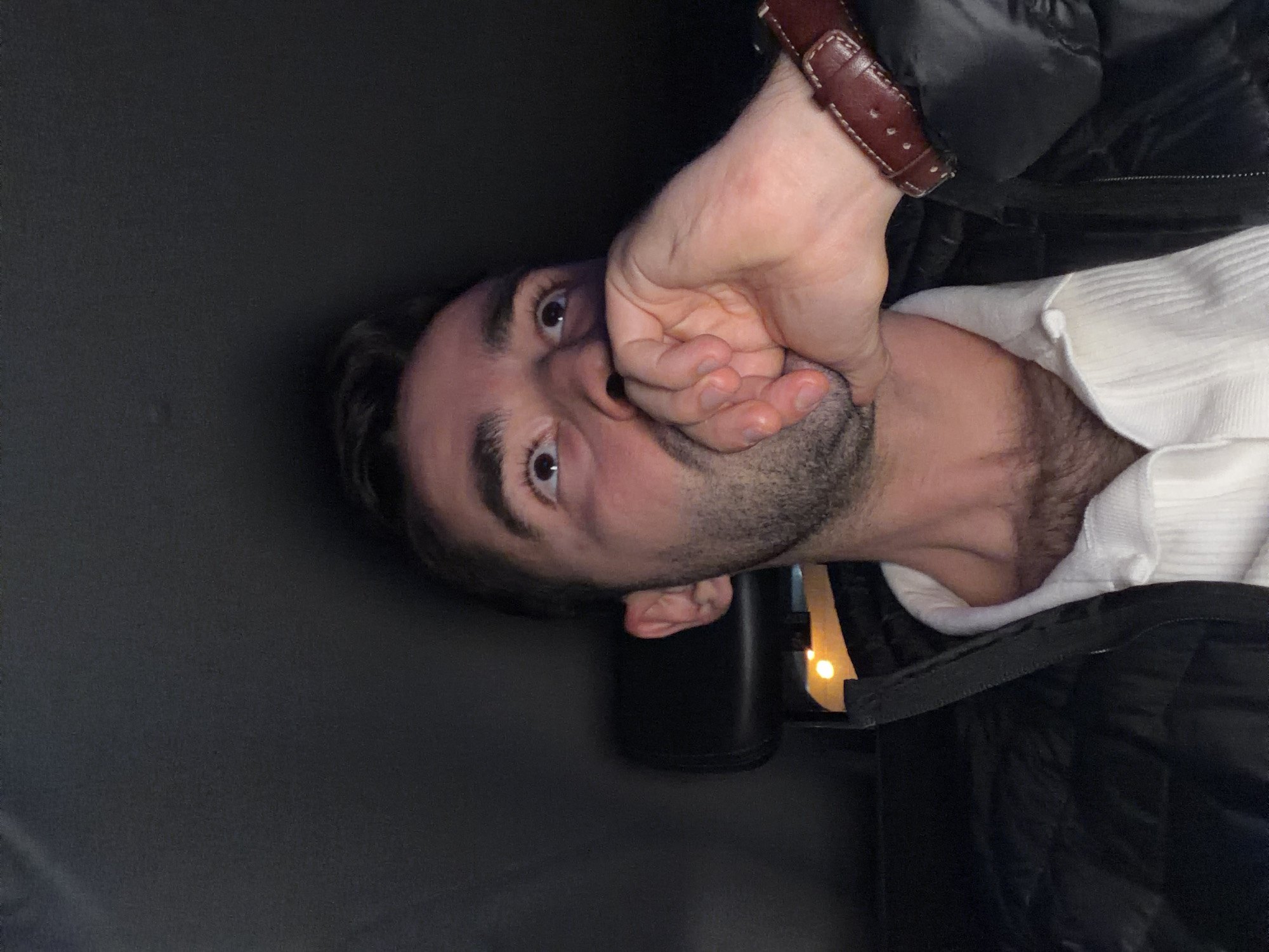 Man covers mouth with hand in Moscow street scene