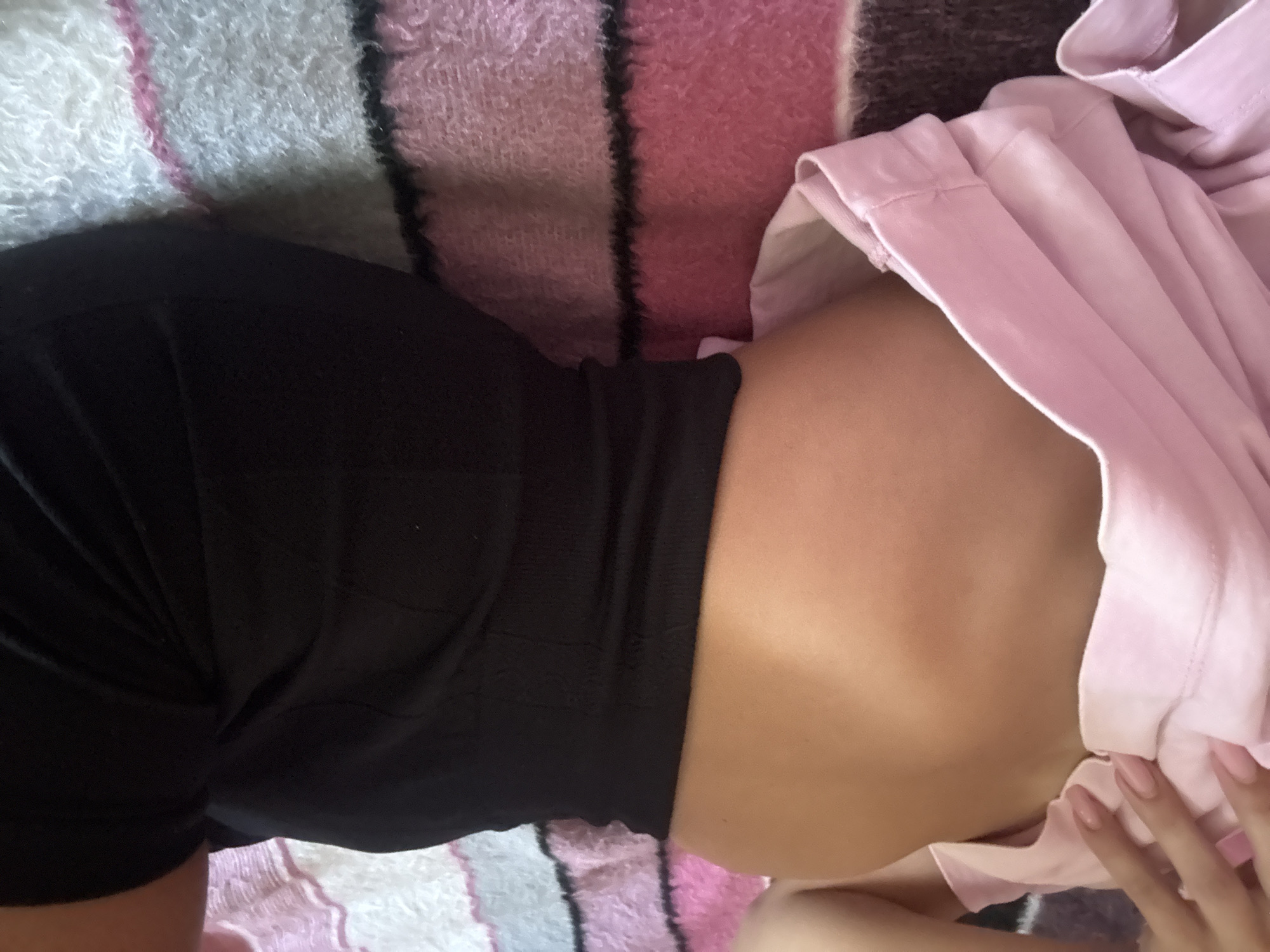 Multiple close-up angles of someone resting on a striped blanket