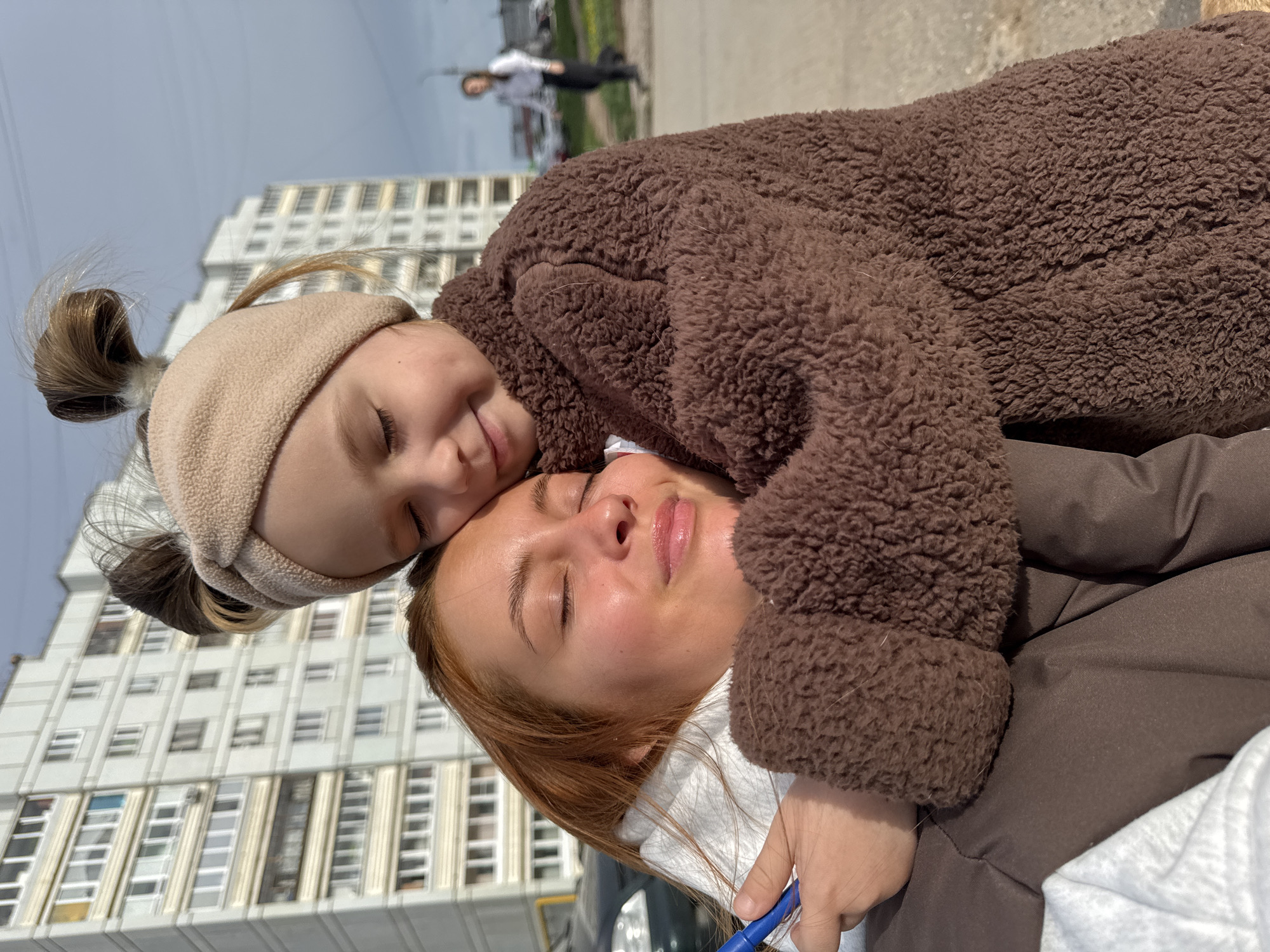 Woman, child walk dog through Chaikovsky on quiet morning