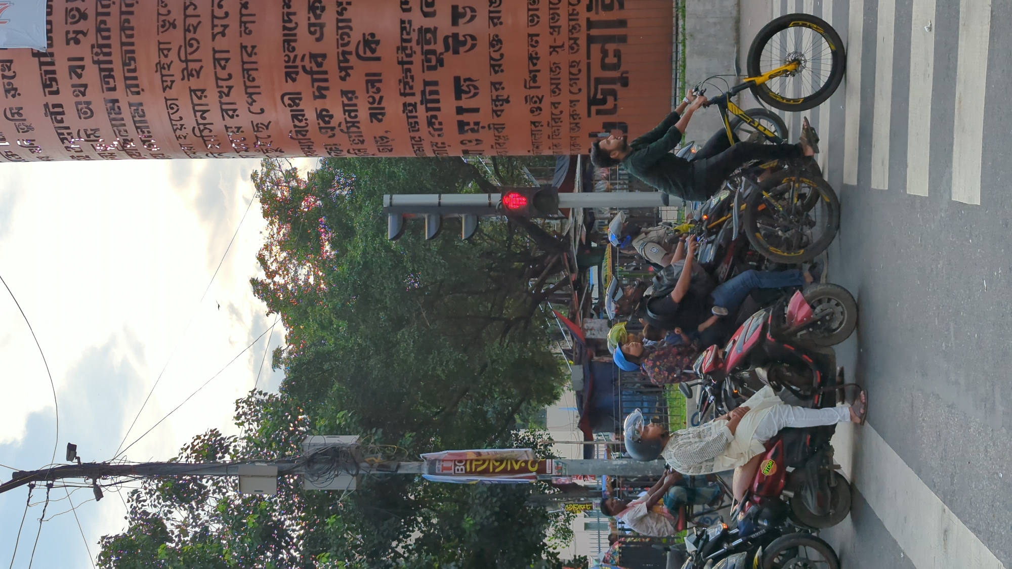 Dhaka street life: rickshaws, cargo, and cardboard sorting
