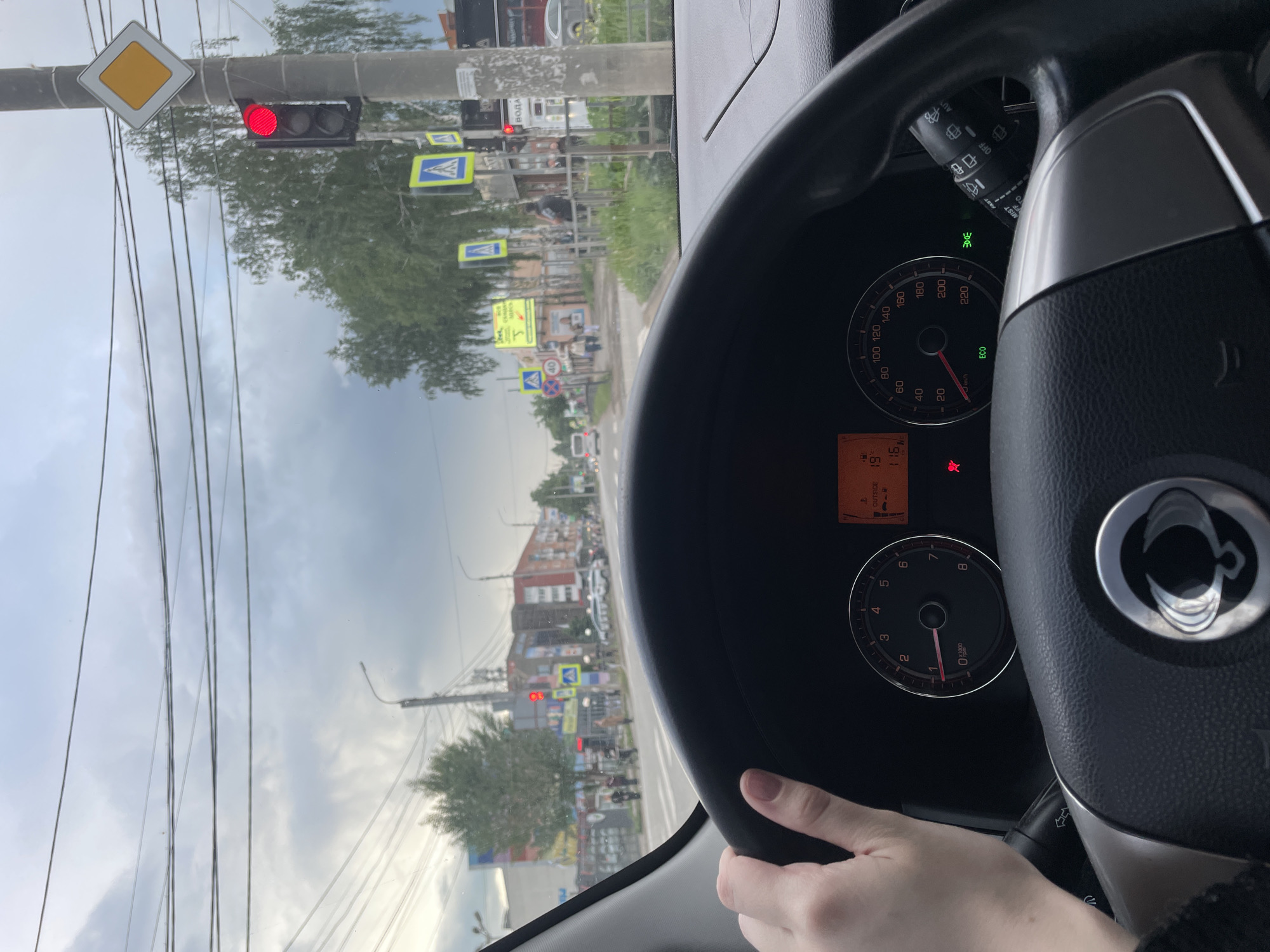 Driver waits at red light in Votkinsk under cloudy skies