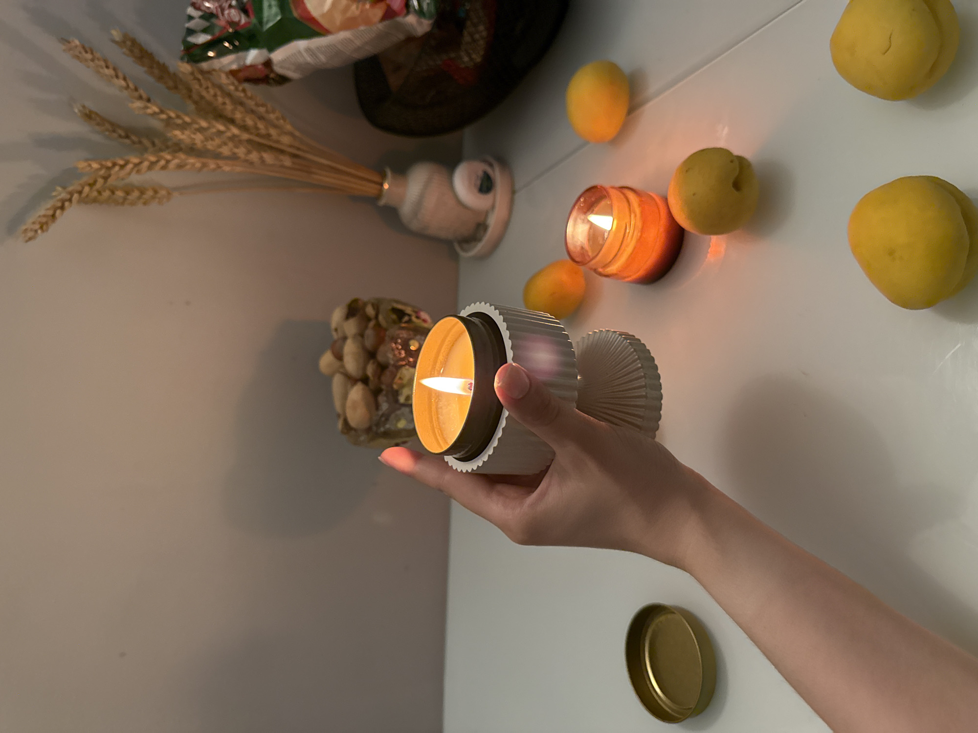 Still life photography session with candles and seasonal fruits