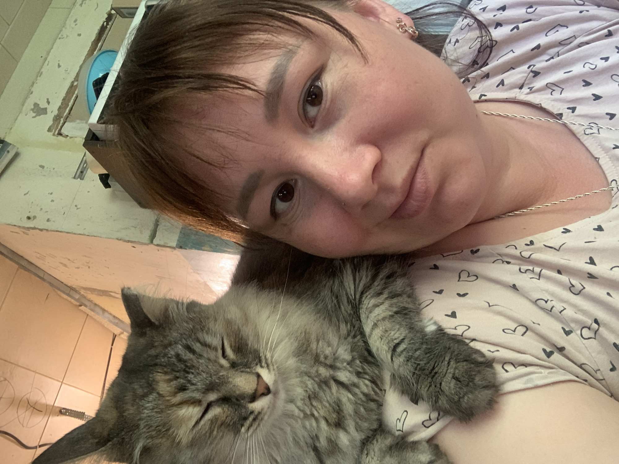 Woman rests with gray cat in Izhevsk