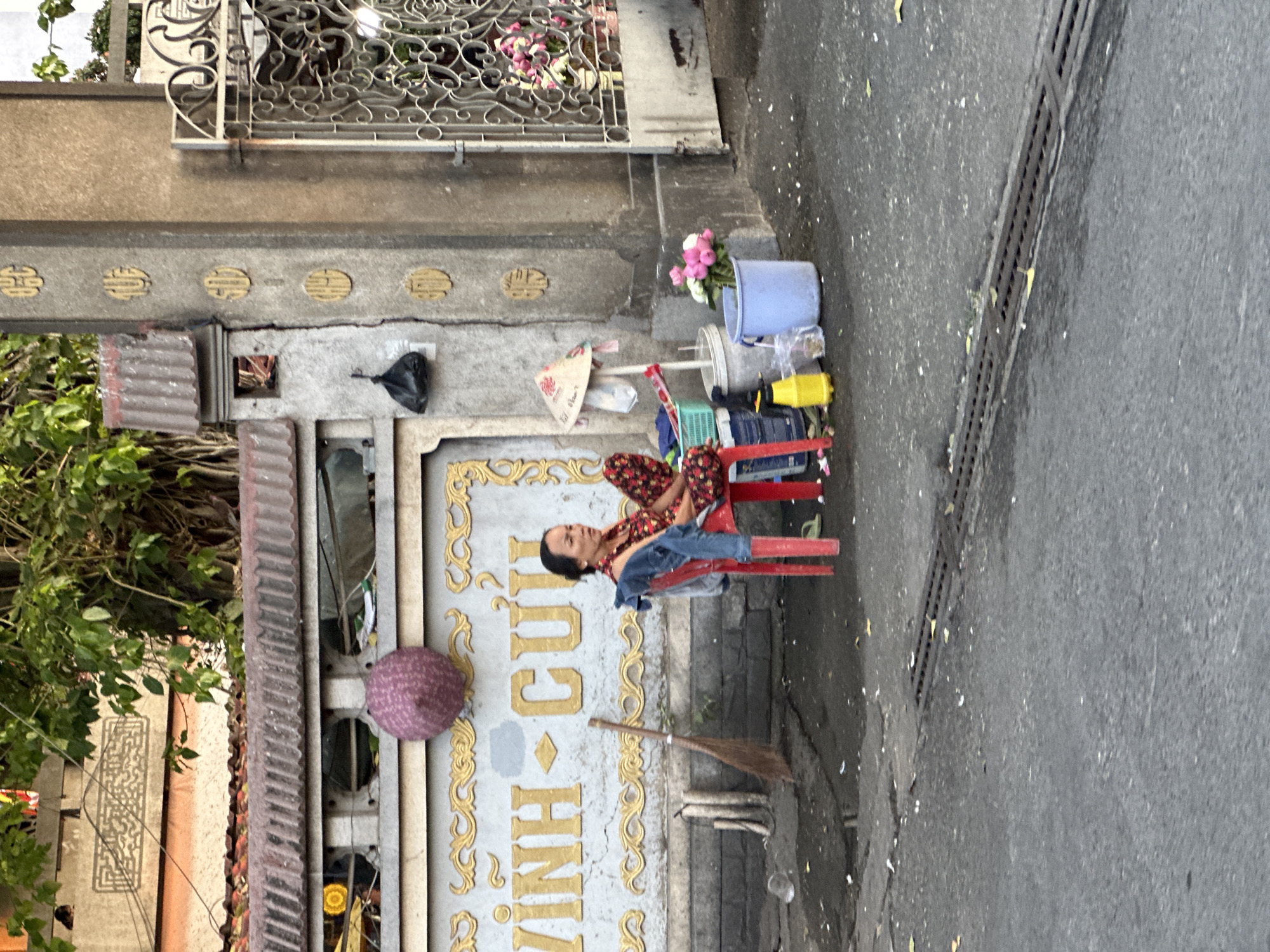 Woman rests on sidewalk chair in Thủ Đức, Vietnam