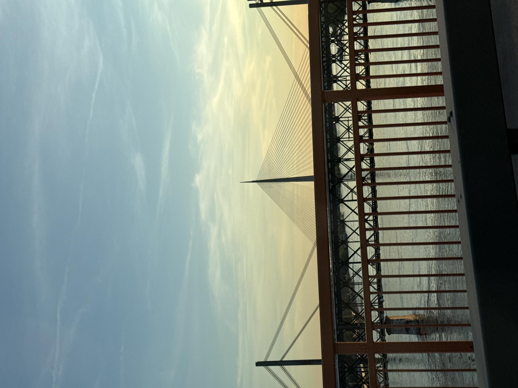 Ada Bridge photographed through orange railings in Belgrade