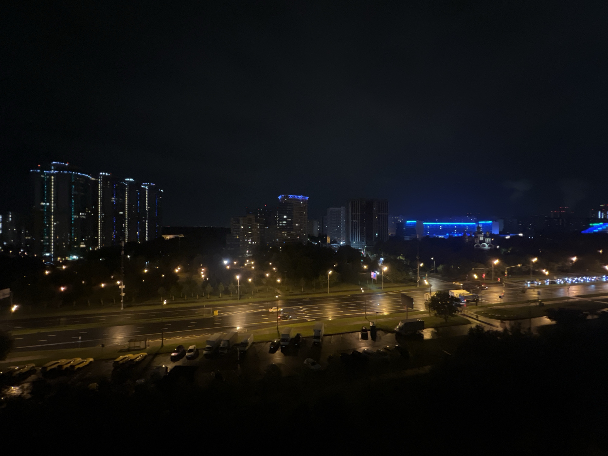 City at night: wet streets, glowing skyline, two angles