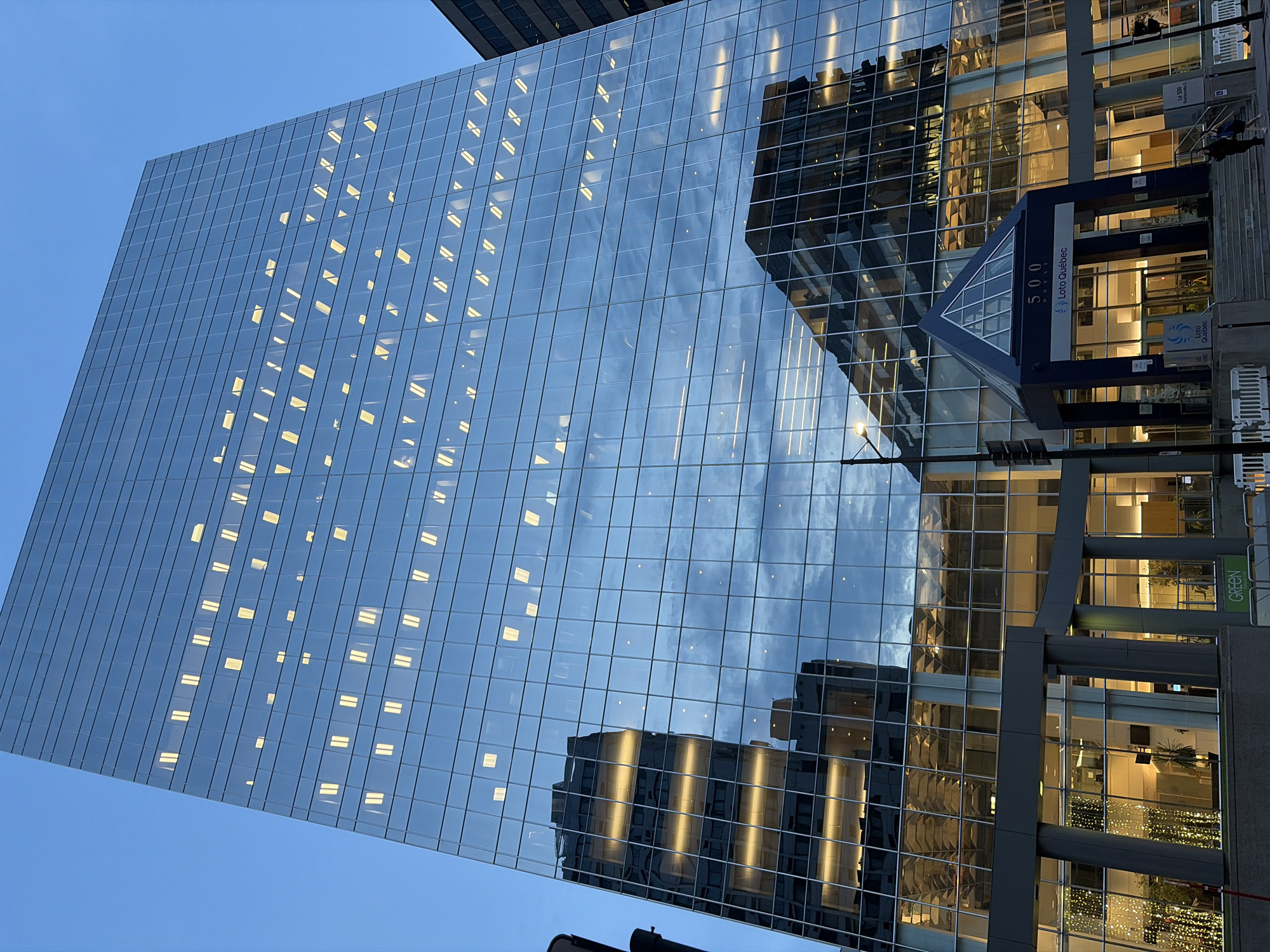 Glass towers catch the last light in a dense city district