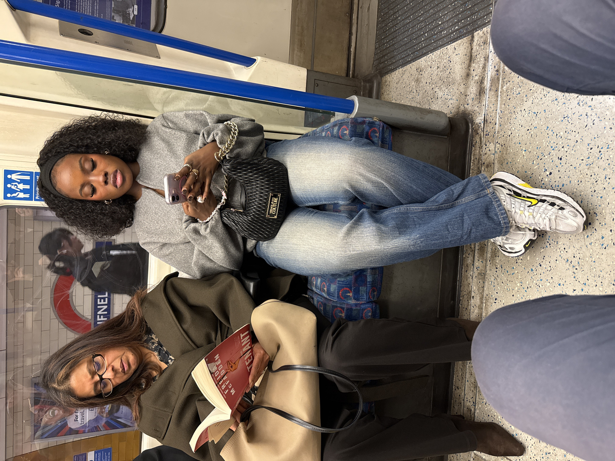 Passengers ride London Underground train during evening commute