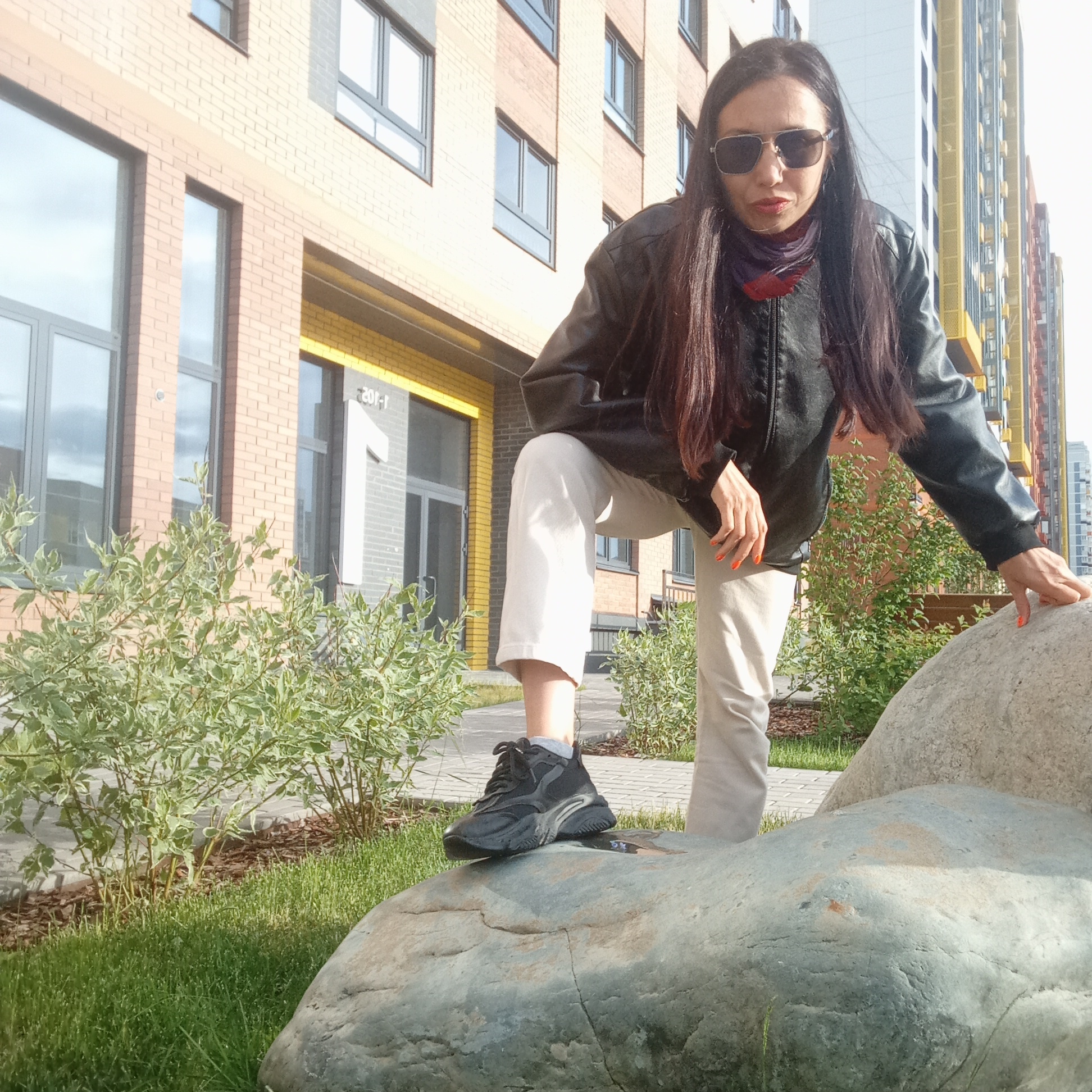 Woman photographs herself around Izhevsk residential buildings Tuesday afternoon