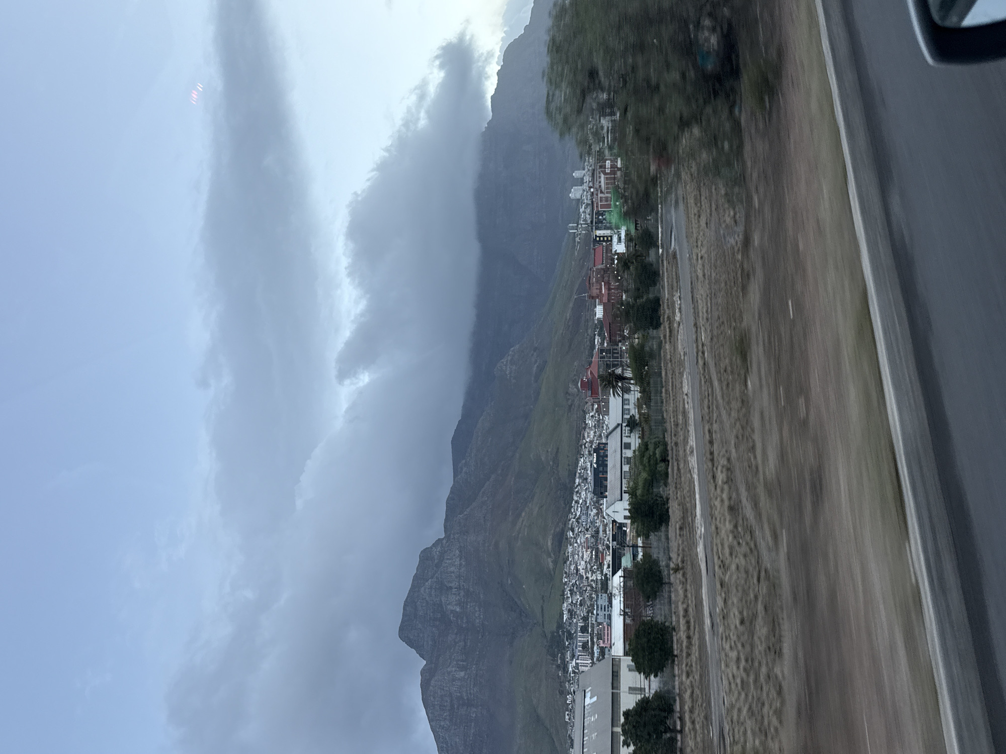 Table Mountain photographed through clouds from Cape Town vehicle