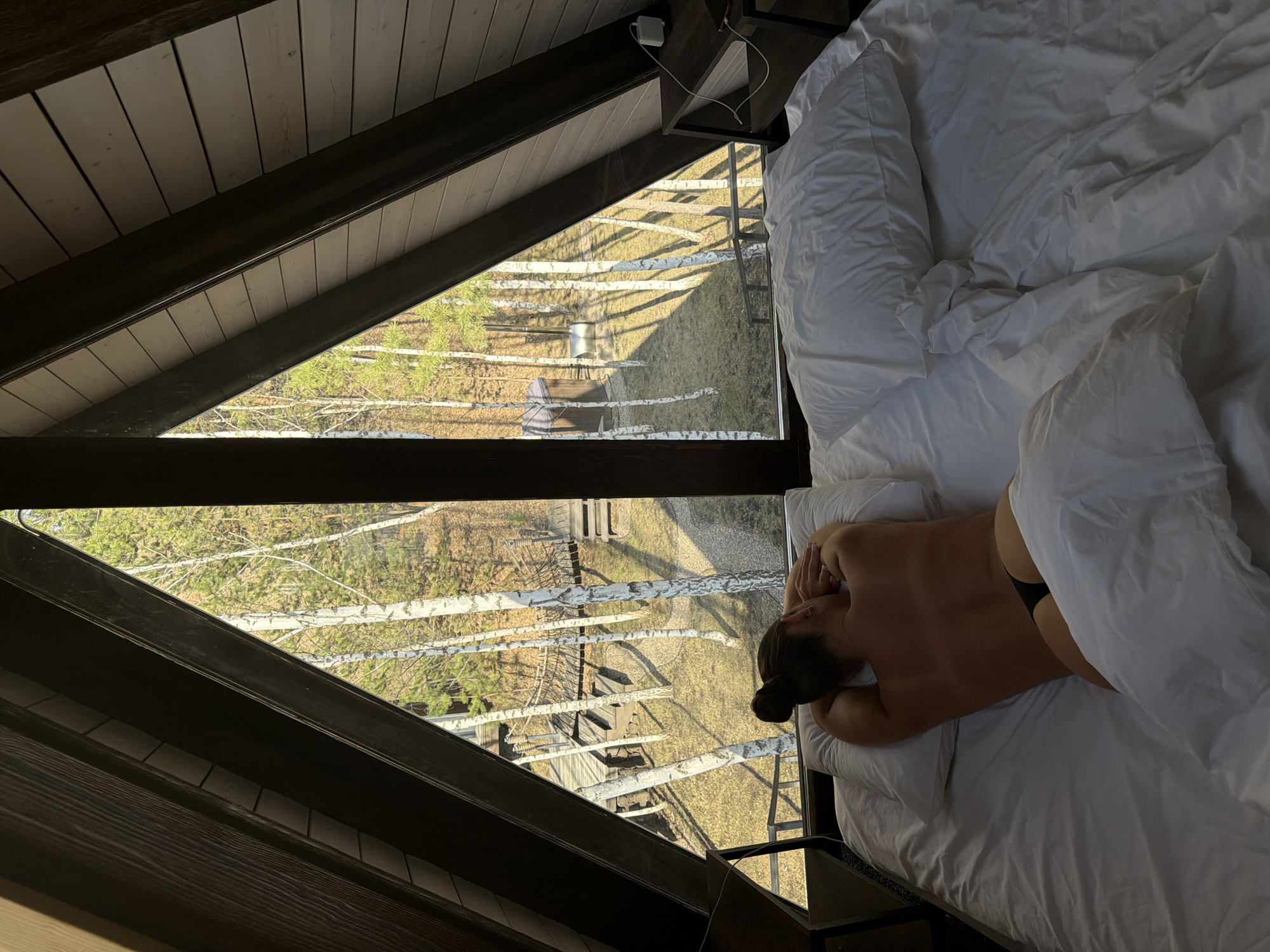 Person resting in bed captured from overhead view in Berezovka