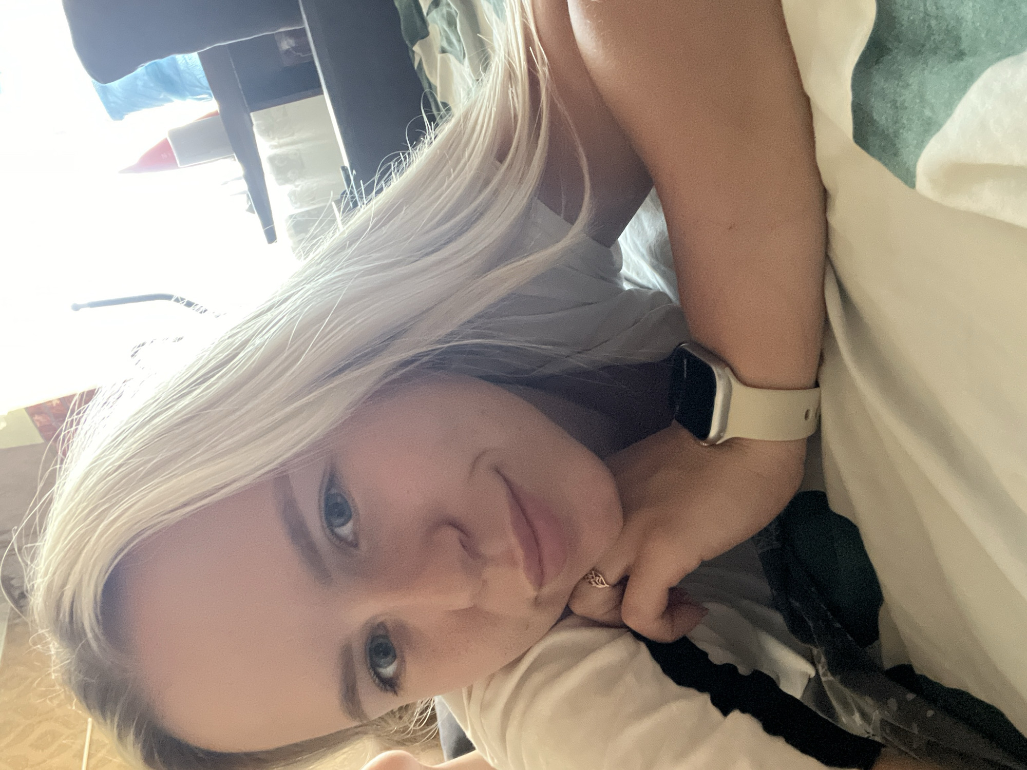 Casual bed selfies in a white tee with a smartwatch