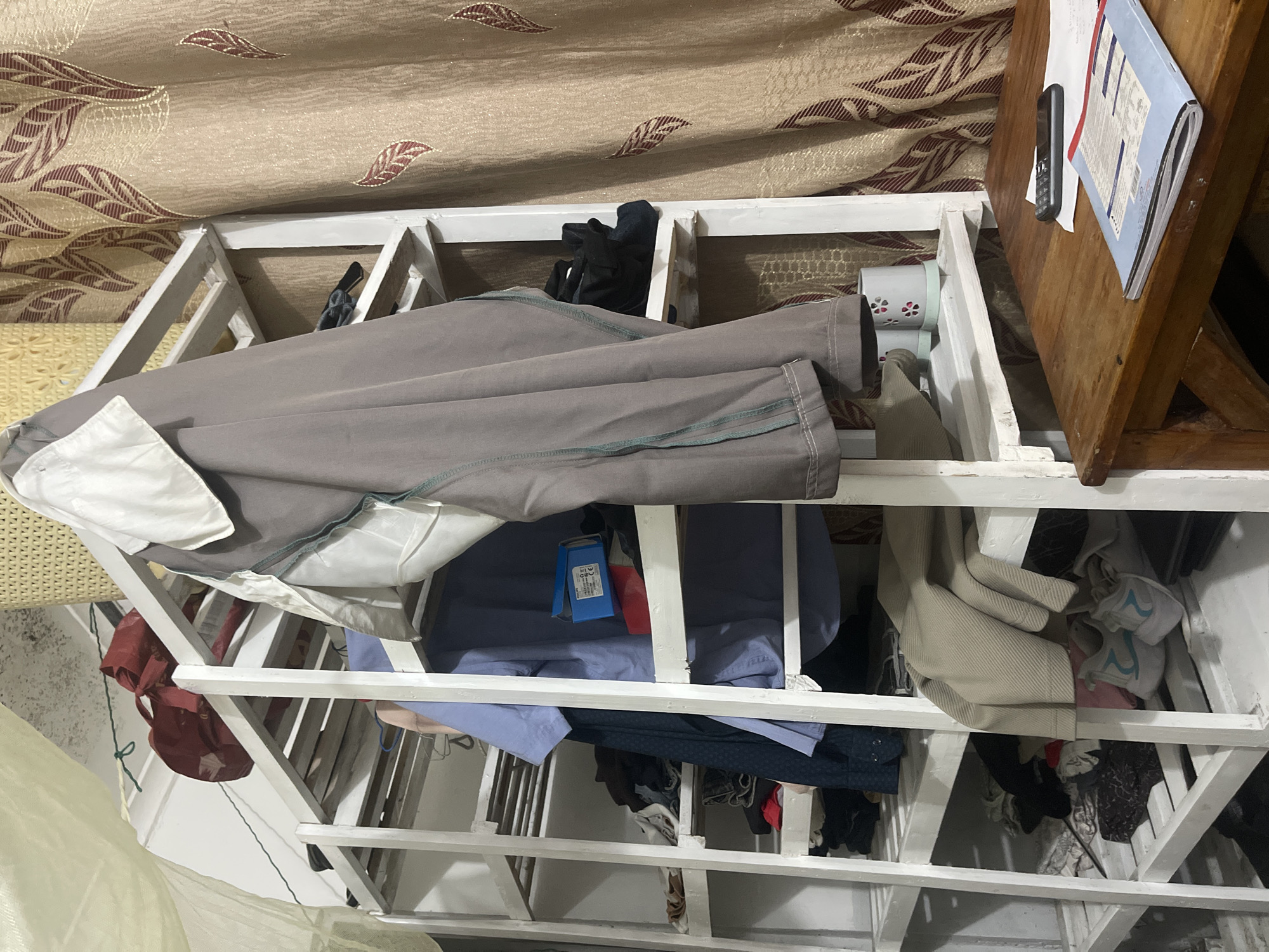 Clothing rack with folded garments observed in Dar es Salaam