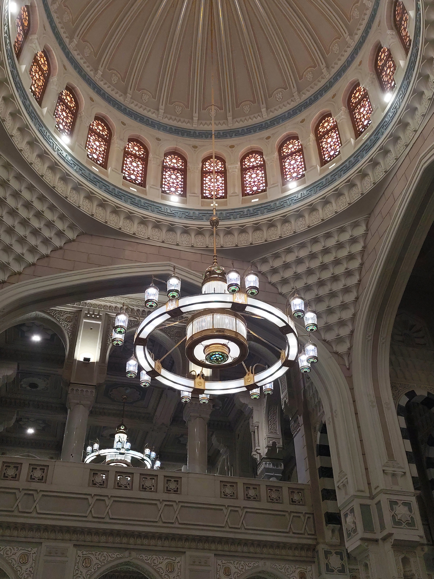Mosque interior with ornate chandelier documented in Makkah