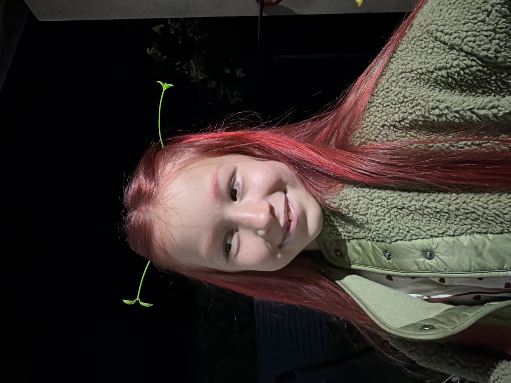 Red-haired person with plant sprouts photographed in Markovo, Russia