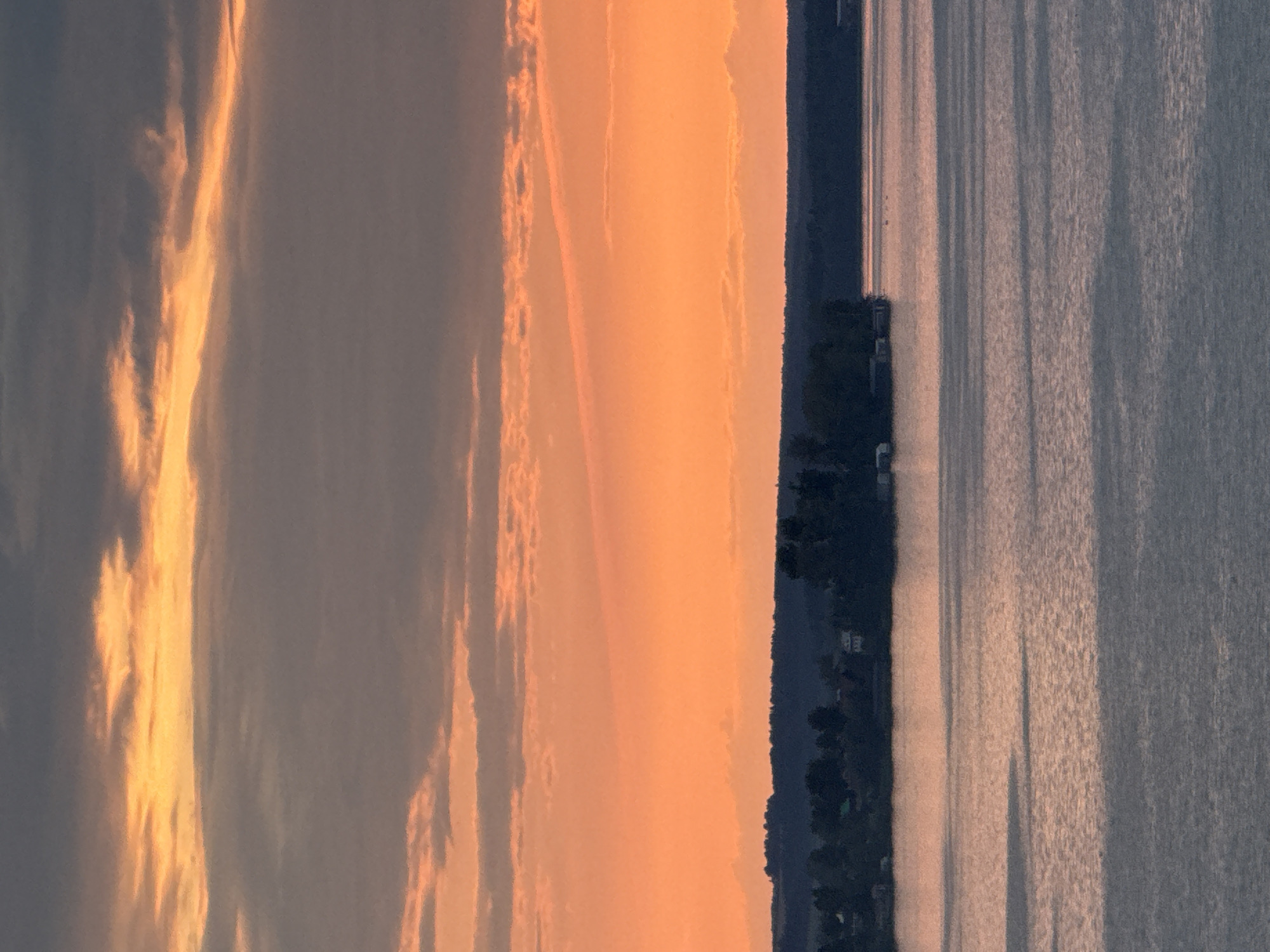 Sunset over a Votkinsk lake, sky blazing orange and pink