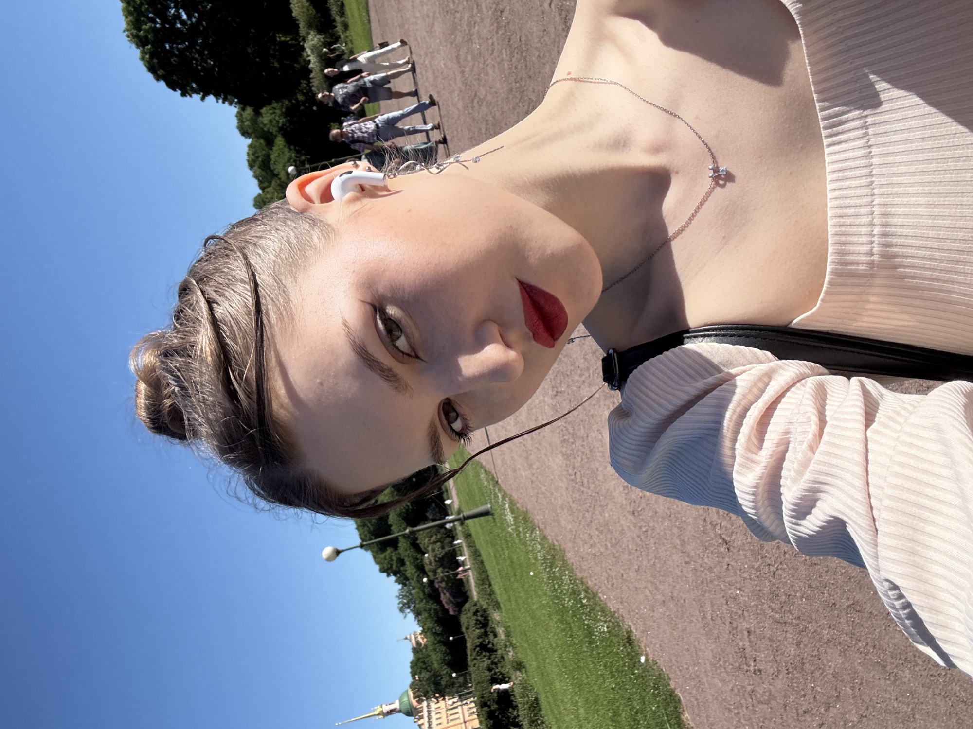 Tourist documents sunny afternoon walk through historic Saint Petersburg landmarks