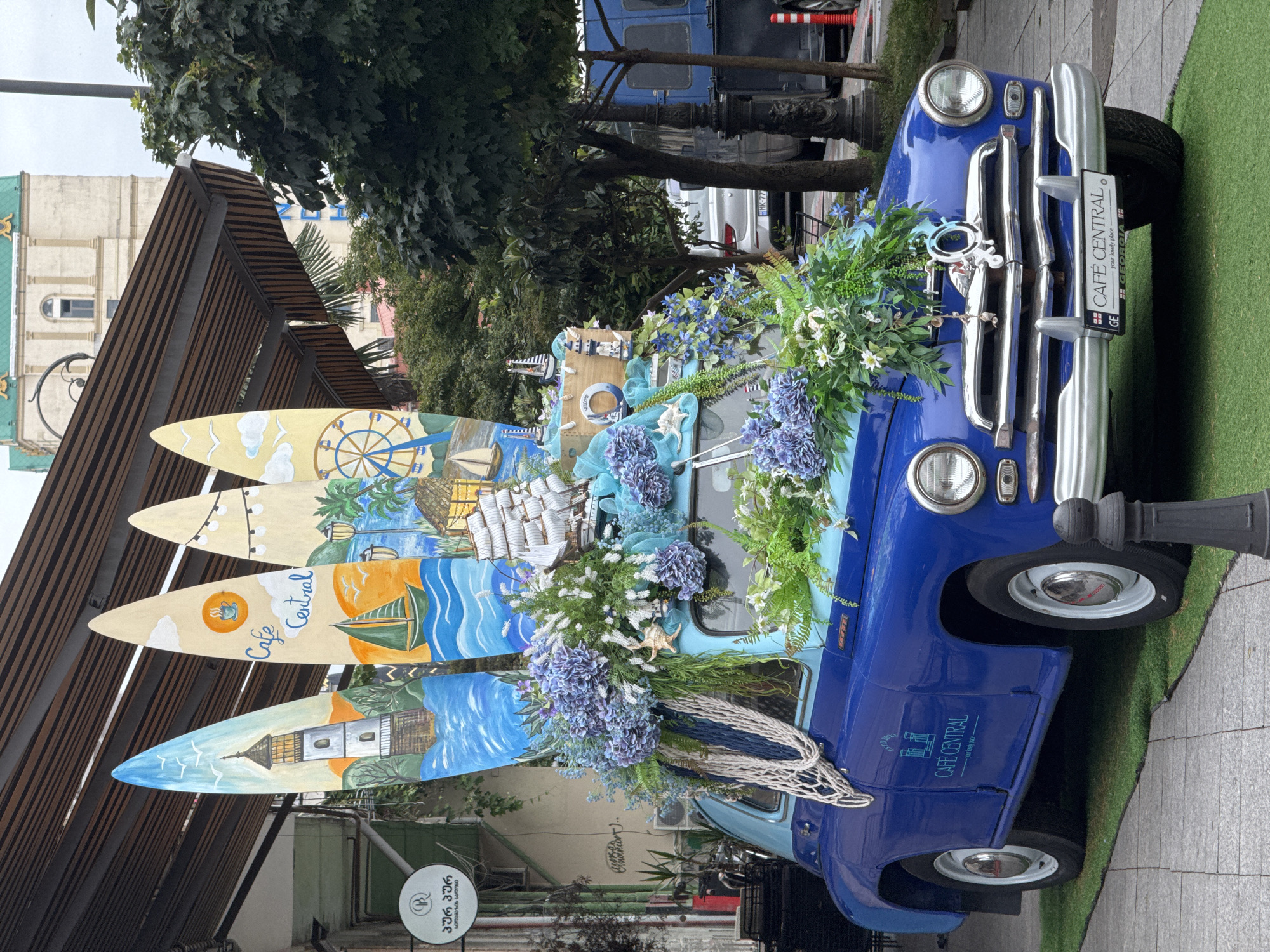 Decorated vintage car and tagged street dog in Batumi