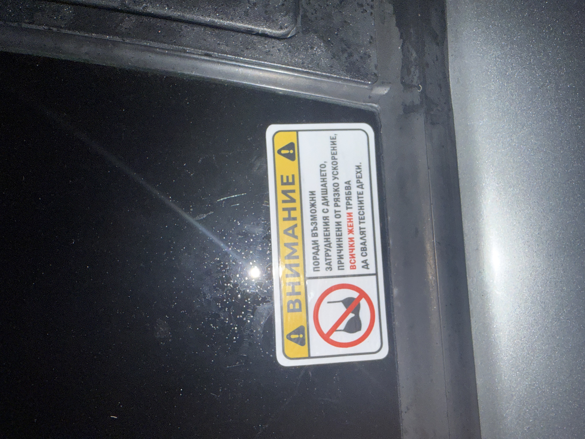 Alfa Romeo parked at night in Burgas, offensive sticker on display