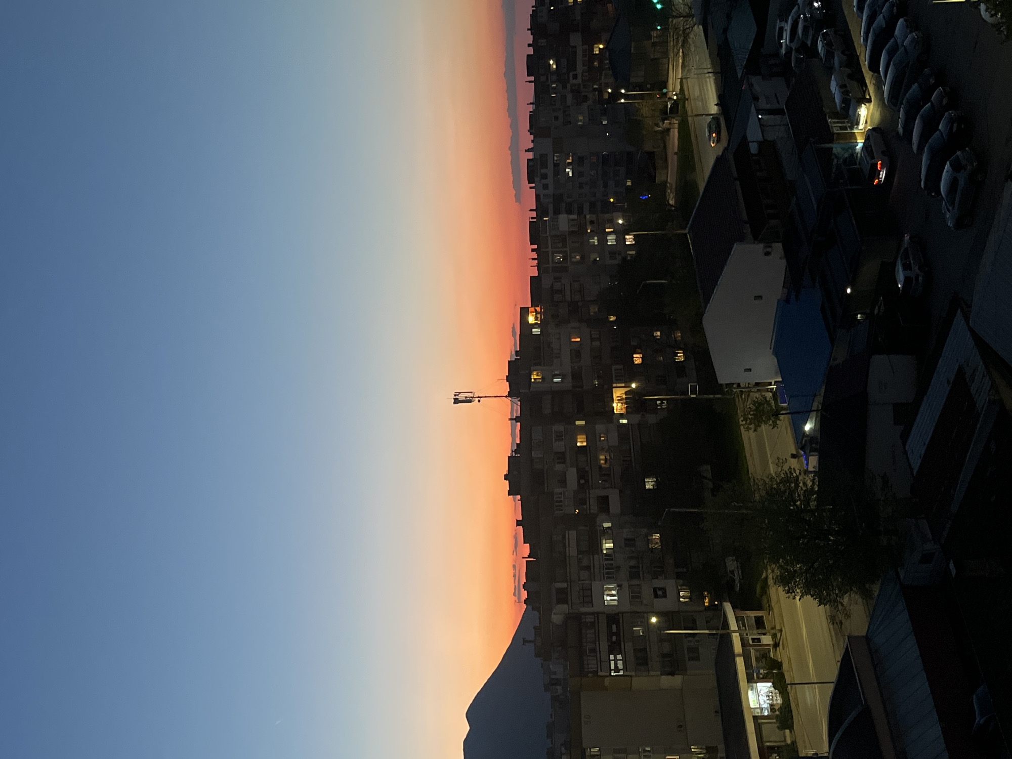 Evening lights illuminate residential Vratsa under twilight sky