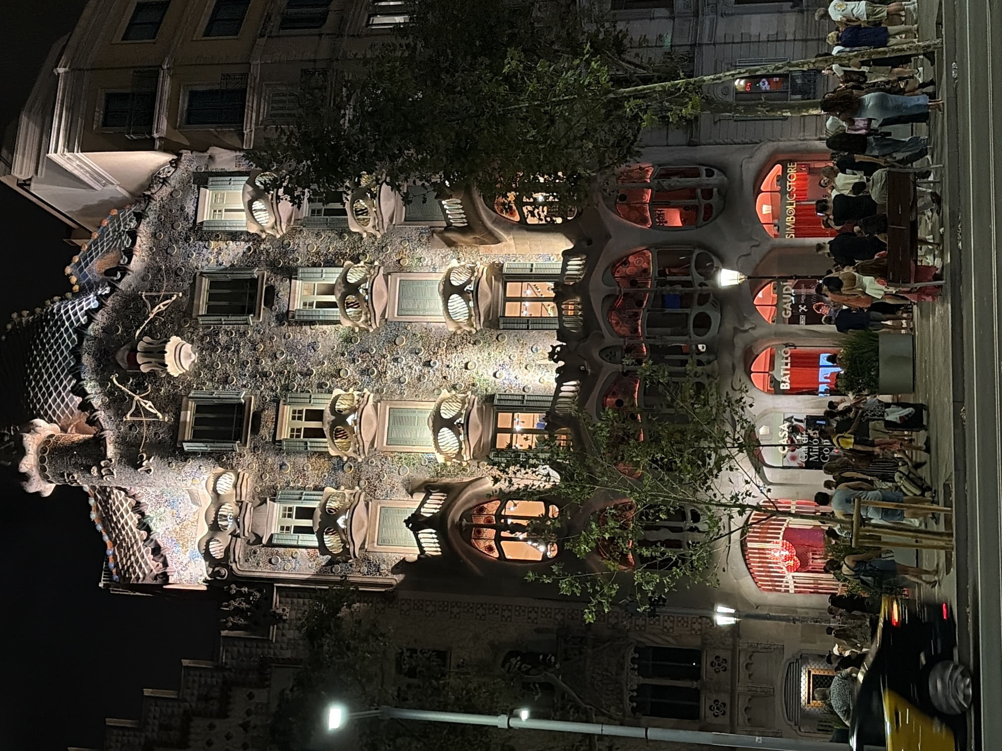 Casa Batlló's illuminated facade glowing on Passeig de Gràcia