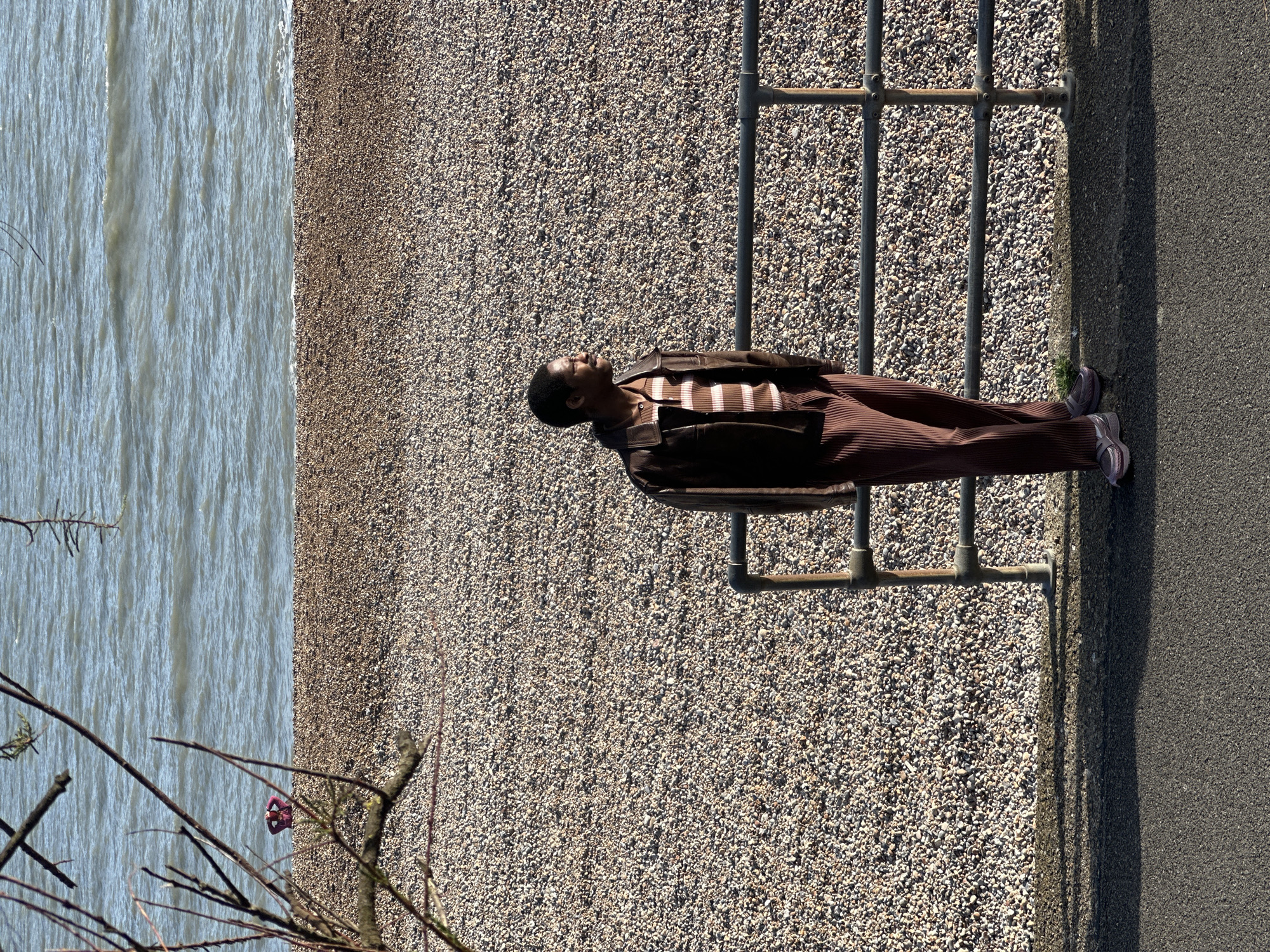 Man lies across beach railing in Folkestone district