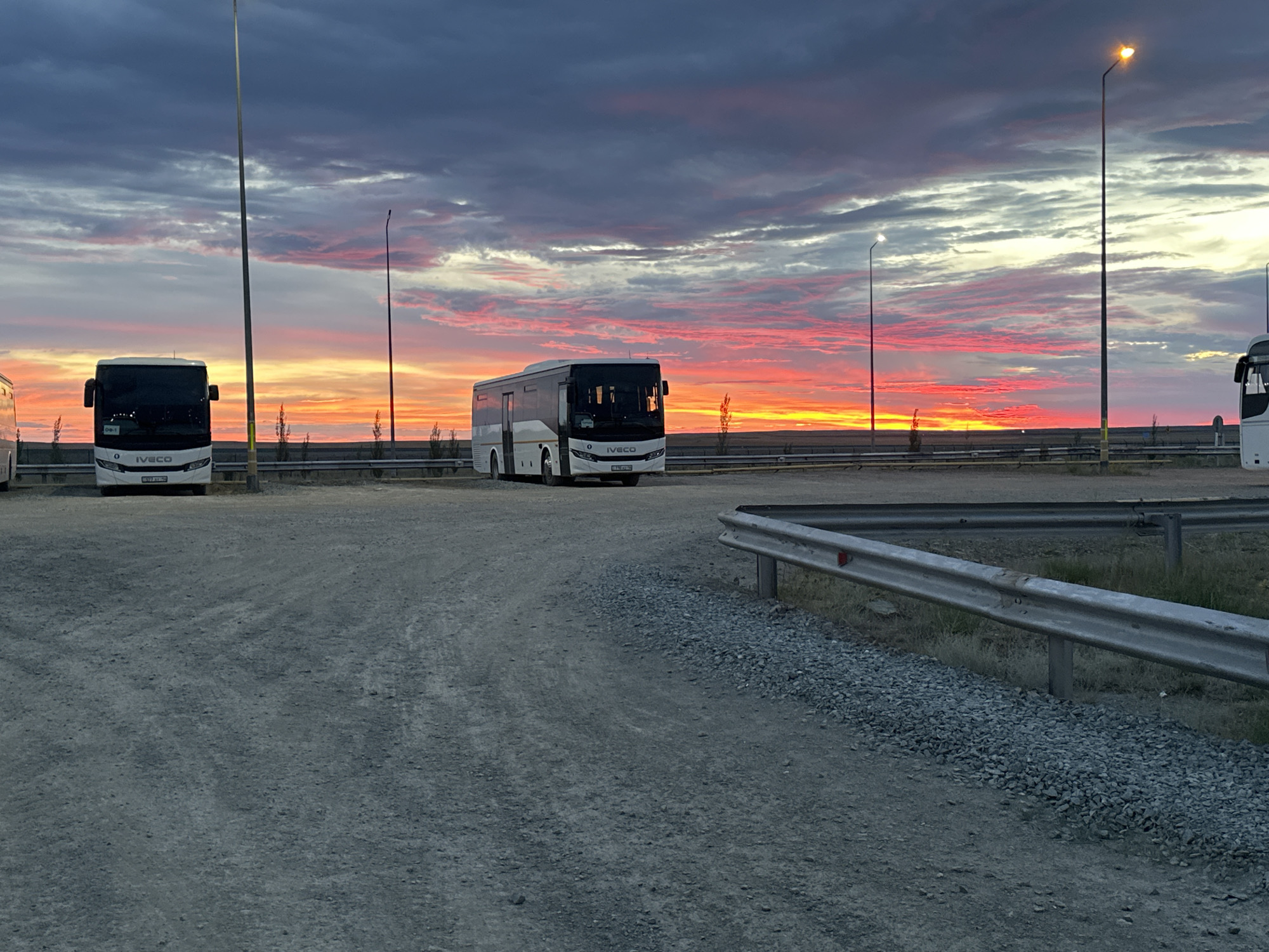 Vivid sunset sky over a Bozshakol parking lot