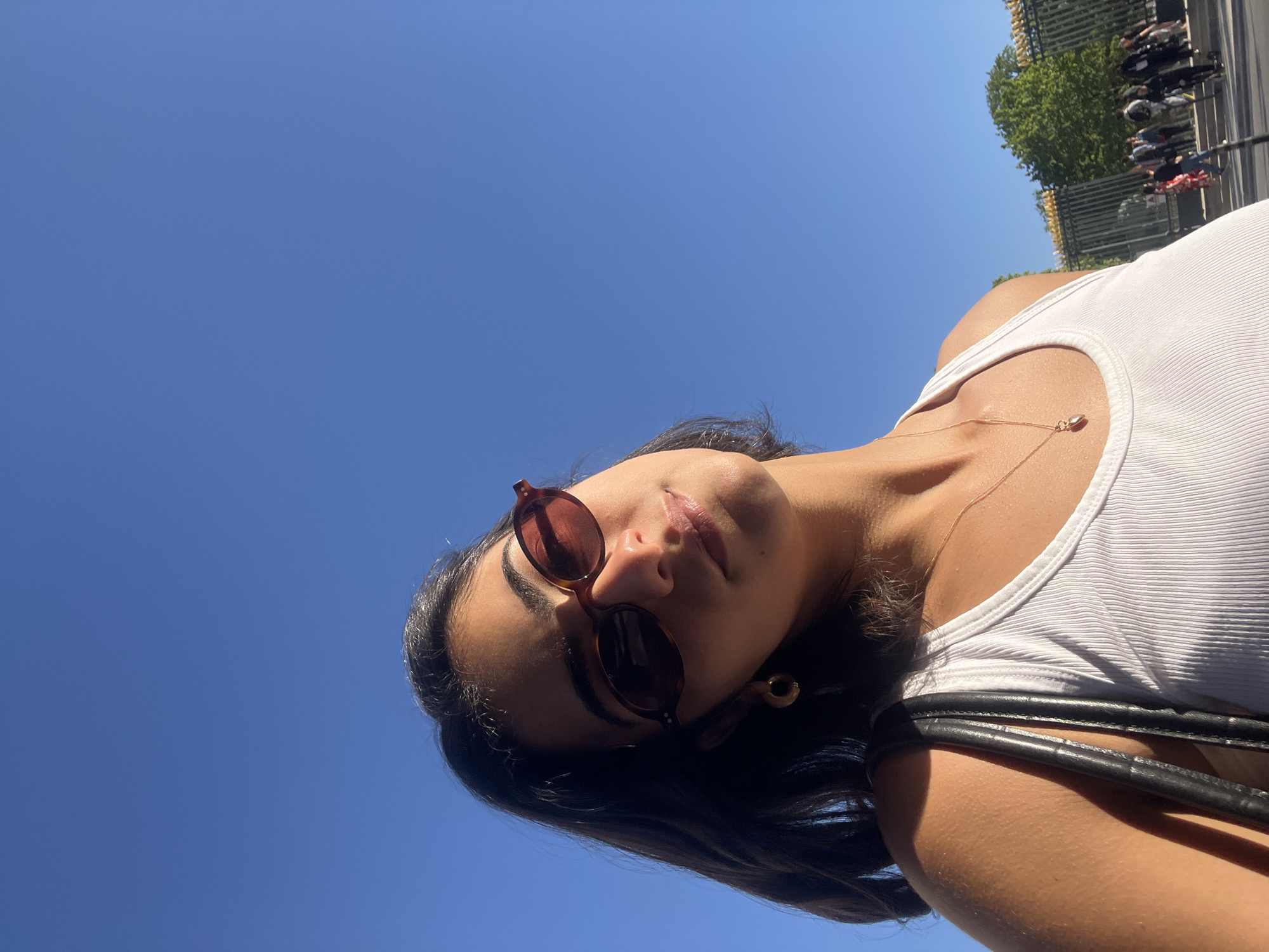 Woman takes selfies in sunny Paris afternoon