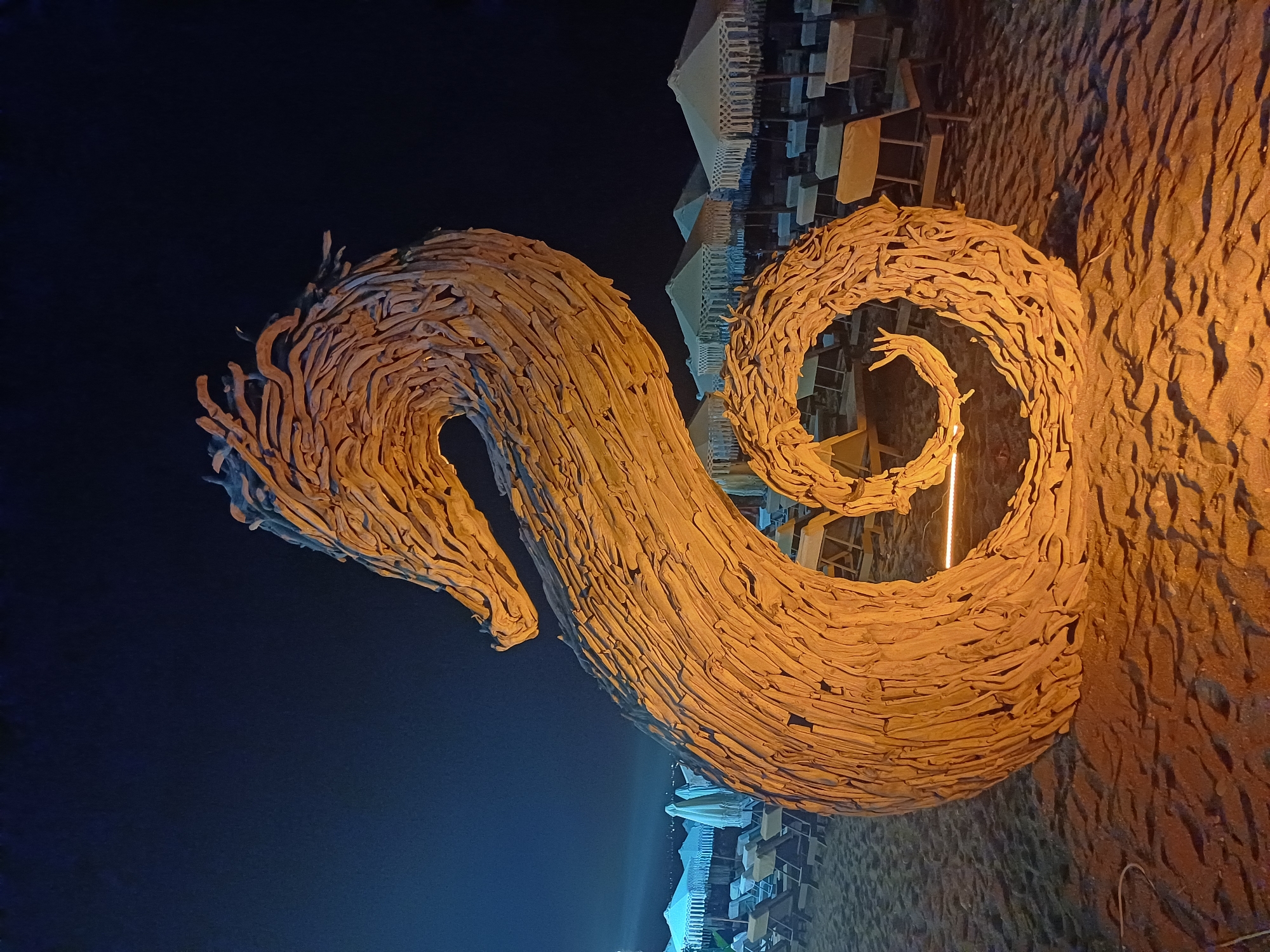 Nighttime Dubai gathering with live music and driftwood seahorse art