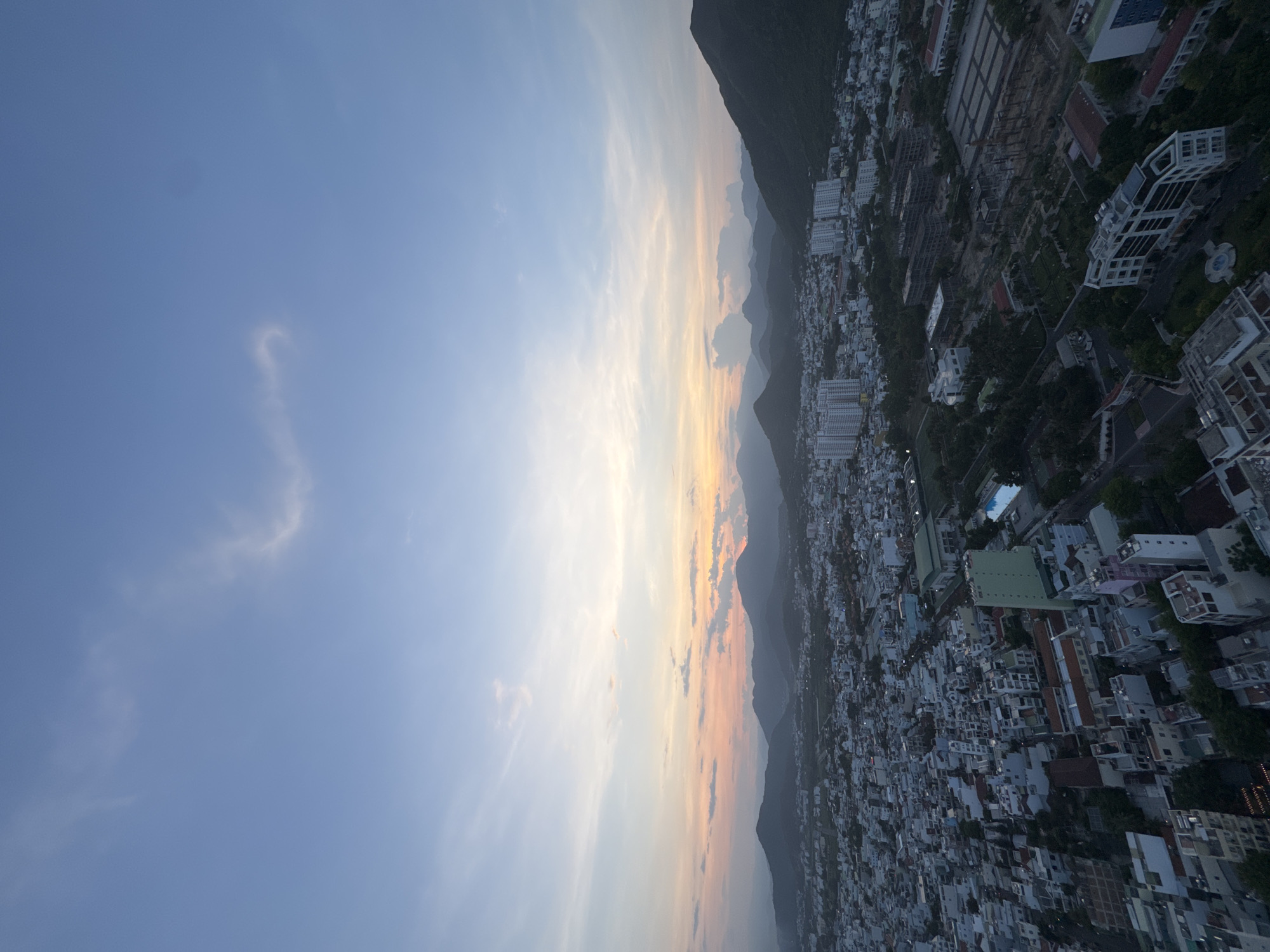Aerial sunset views of coastal mountain city