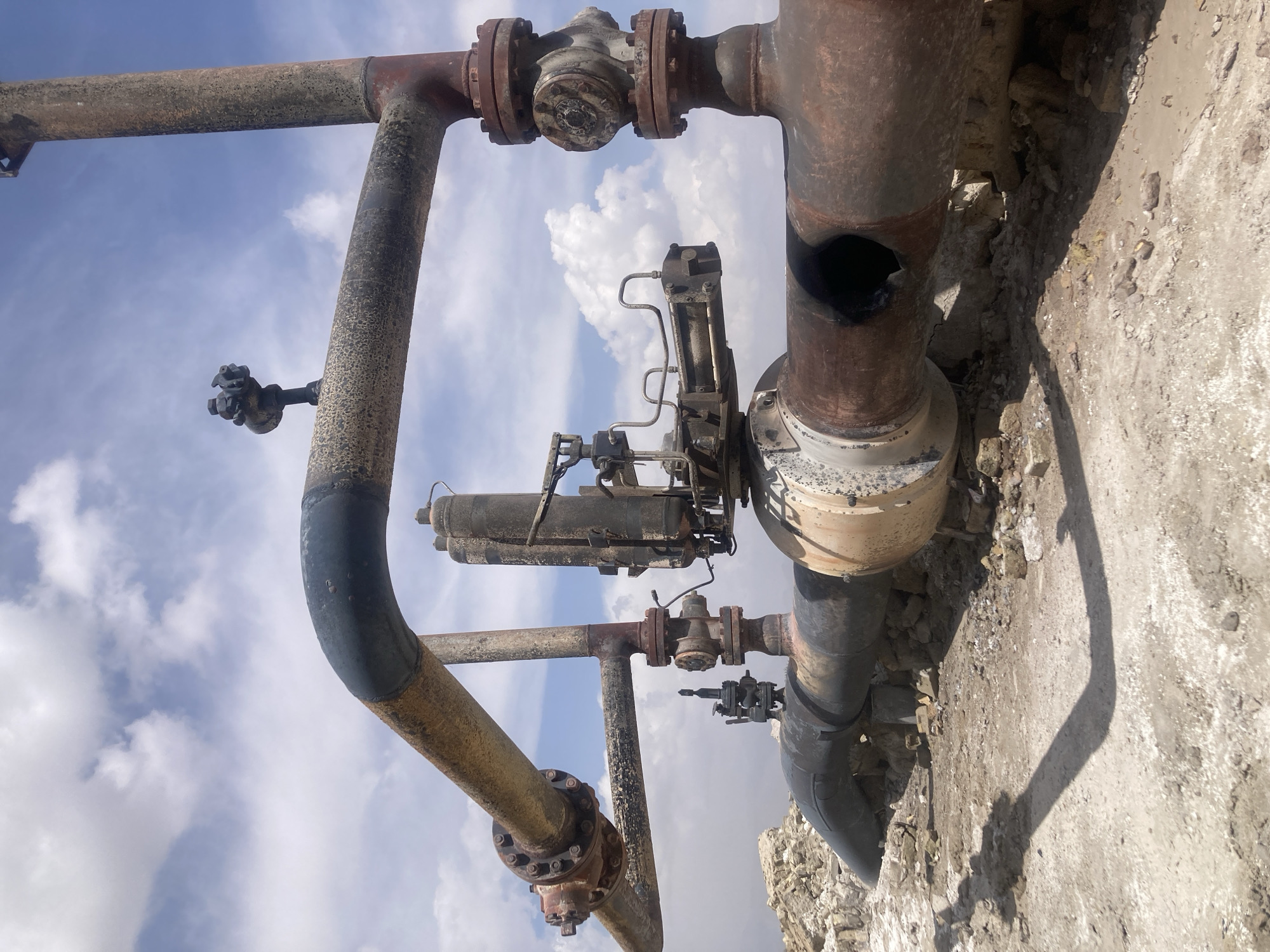 Industrial infrastructure shows extensive corrosion and damage