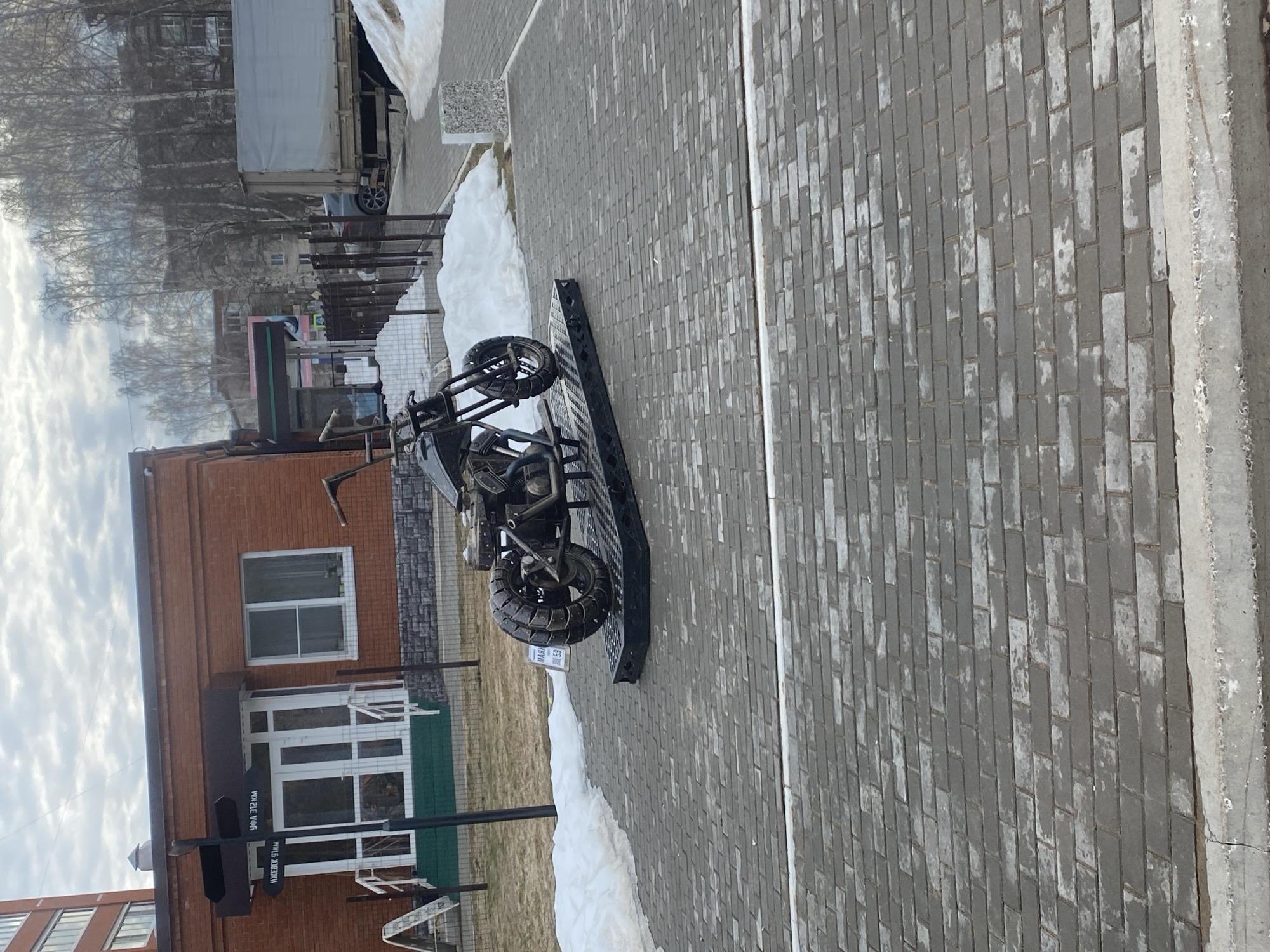 Trike motorcycle parked on sidewalk in Chaikovsky, Russia
