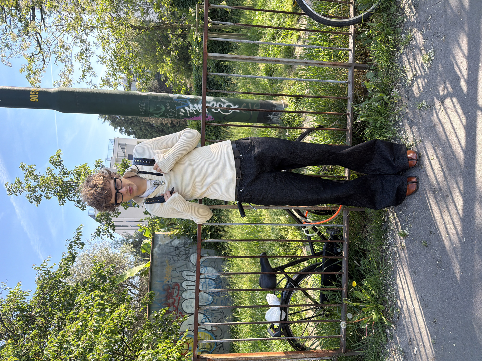 Portrait captured beside rusty fence in Milan