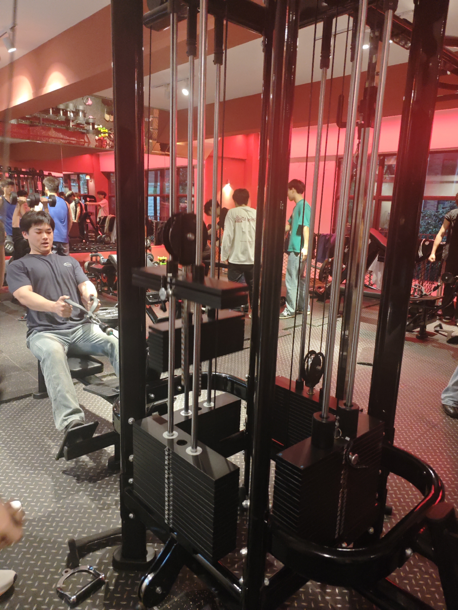 Man exercises on cable machine at Chongqing gym
