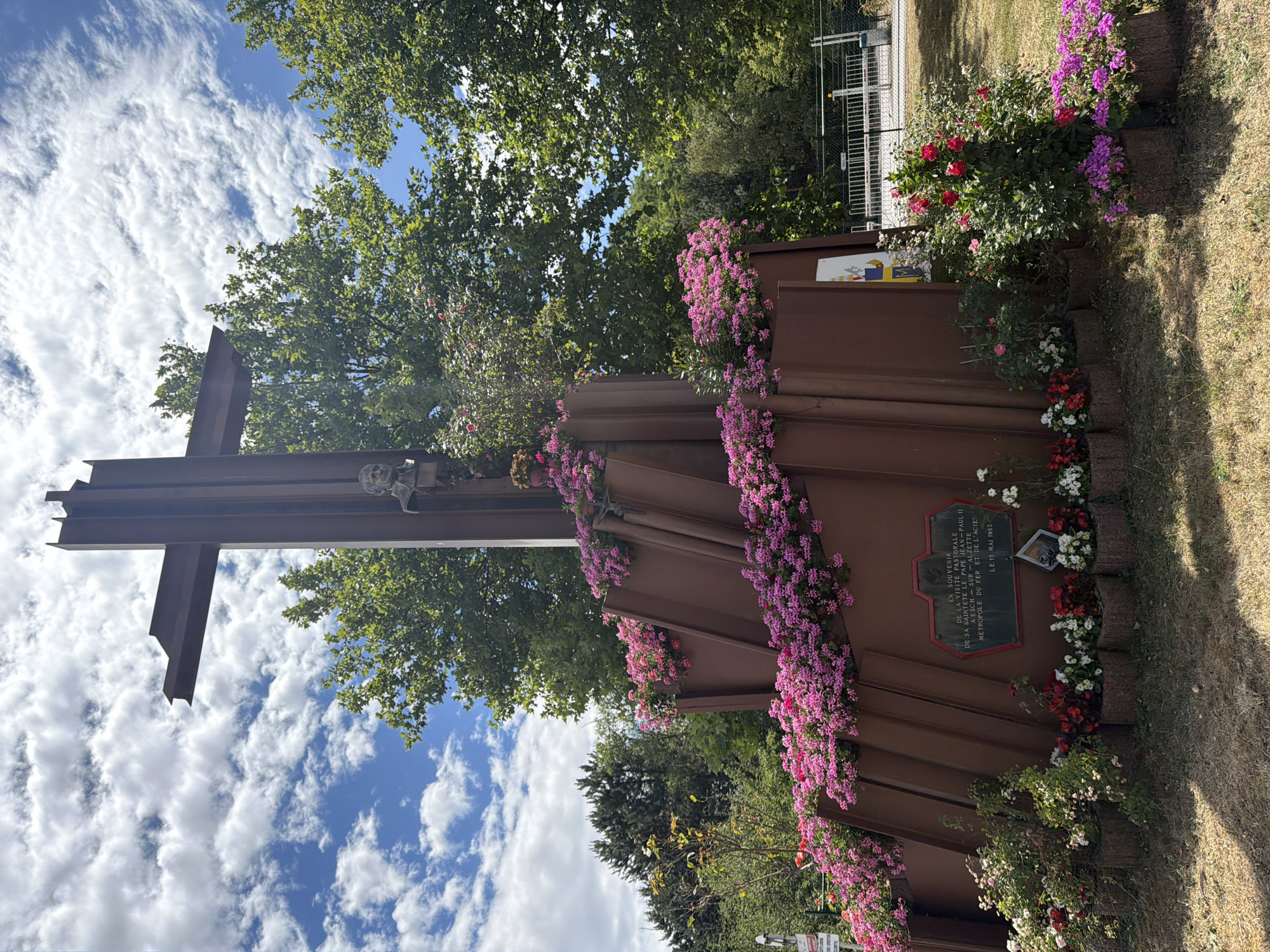 Metal cross memorial with bronze bust in Esch-sur-Alzette