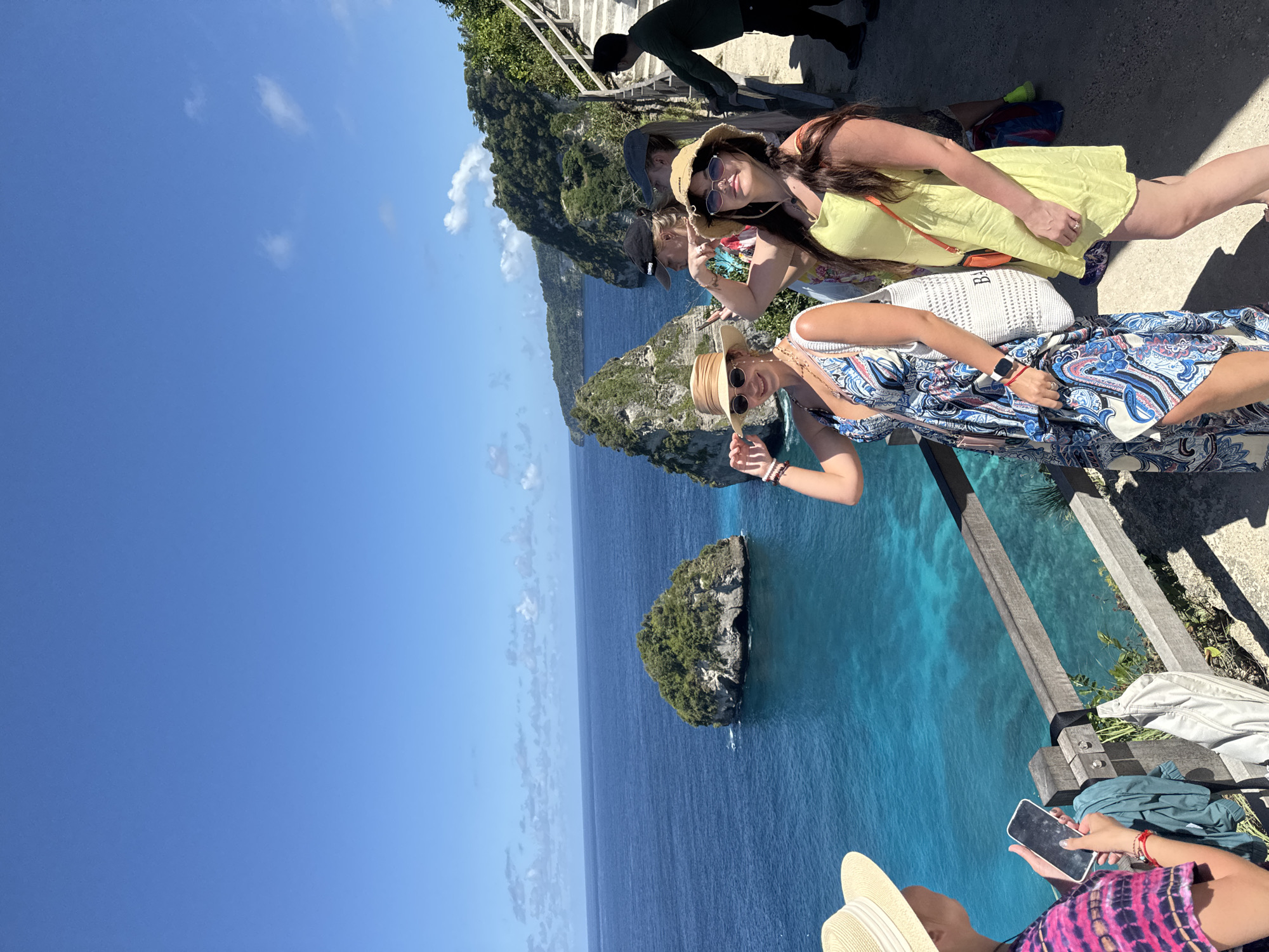 Four women pose at scenic Nusa Penida cliff viewpoint