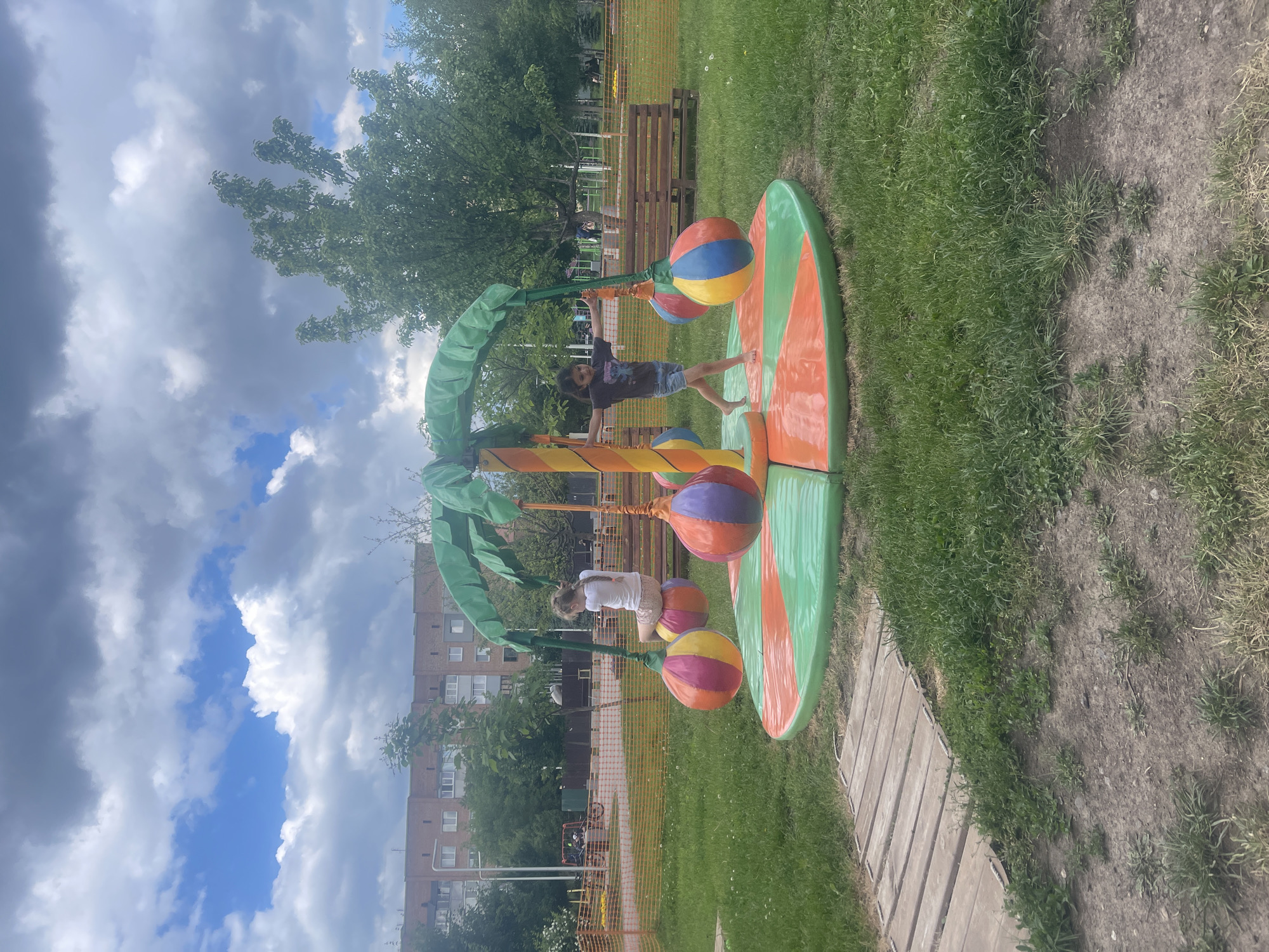 Children play at jungle-themed playground as pigeon forages nearby