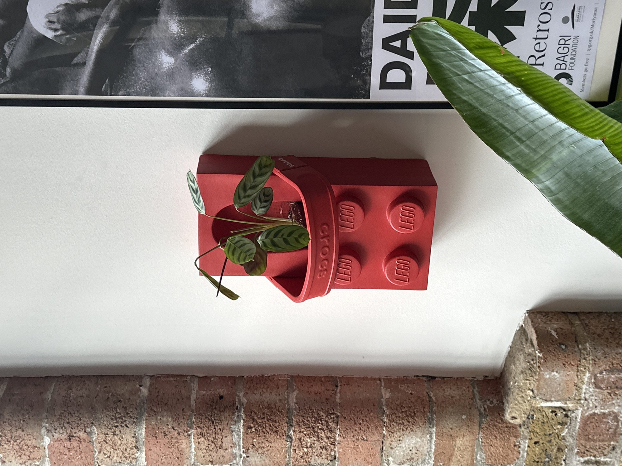 Red Lego Croc-shaped planter spotted on London wall