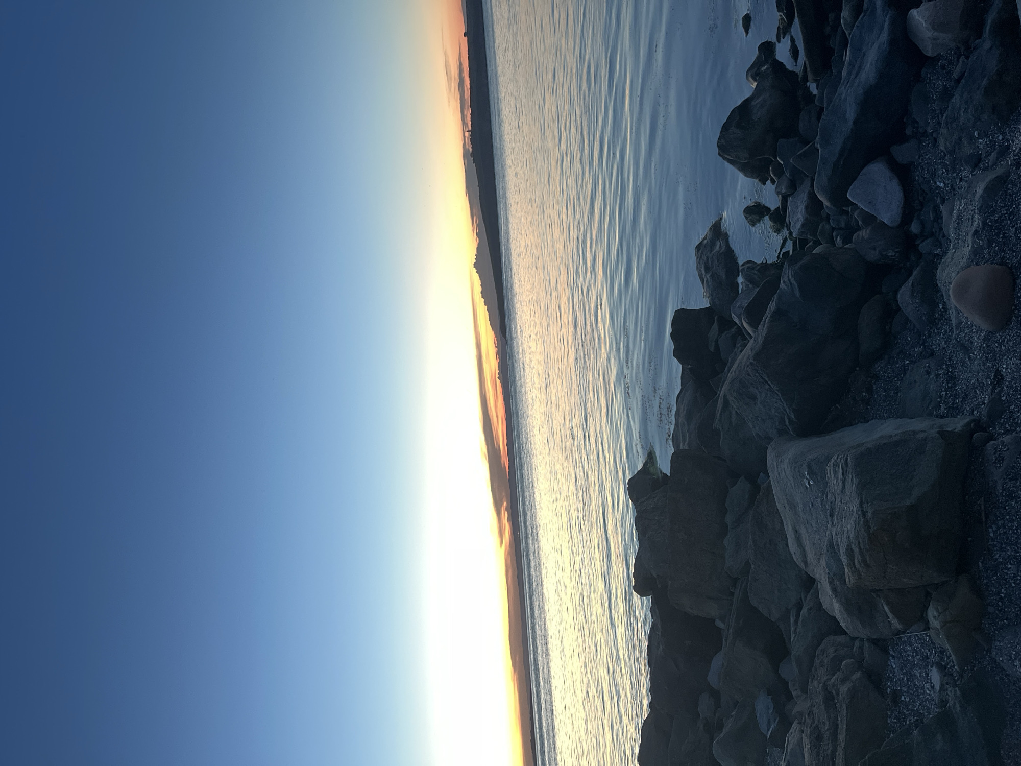 Twilight stroll along Sozopol's rocky coastline at sunset