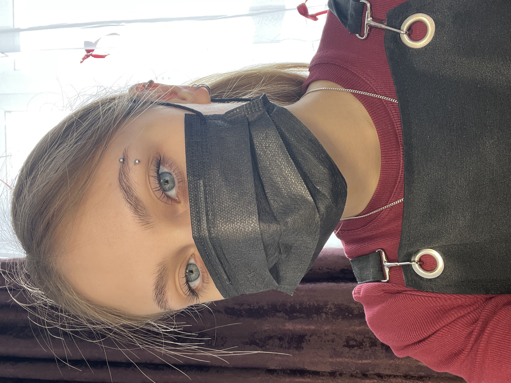 Young person with piercings photographed in selfie shots