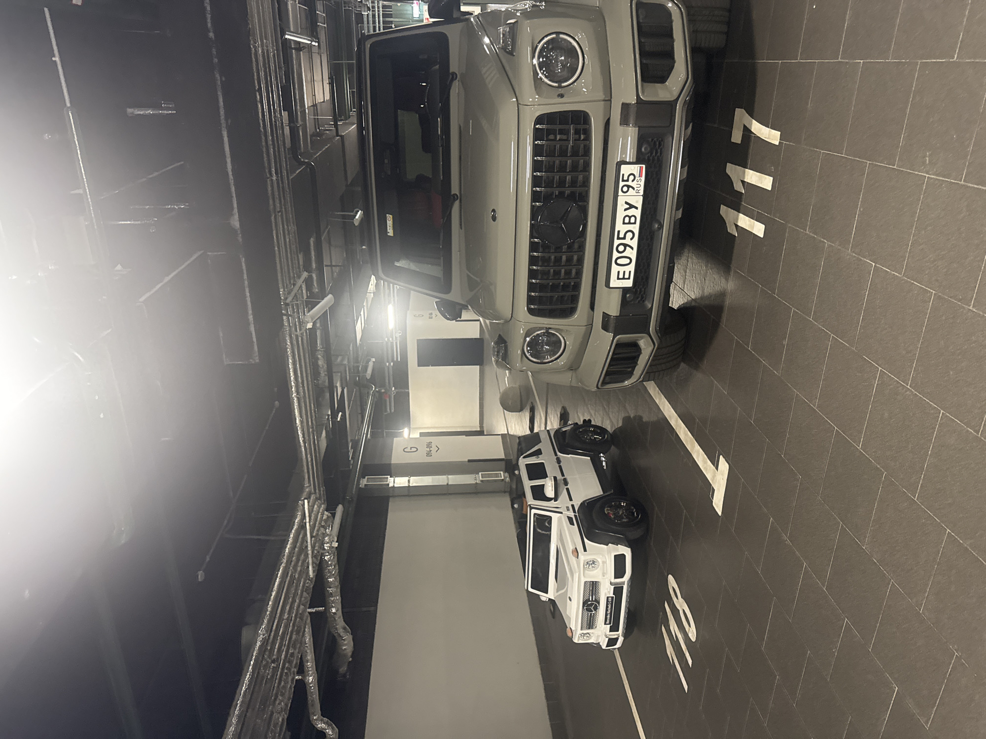 Full-size and toy G-Wagon parked side by side in Moscow garage