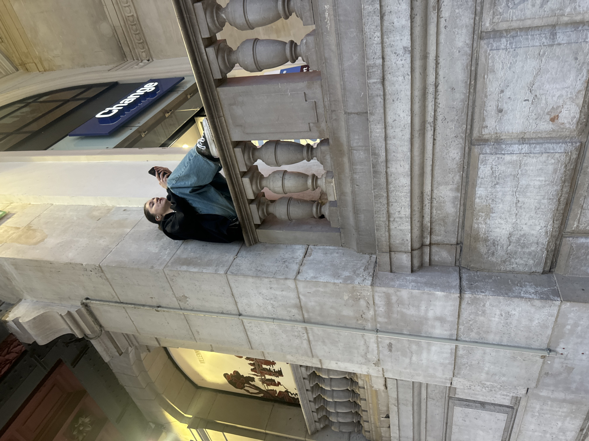Person sits on stone ledge in Paris