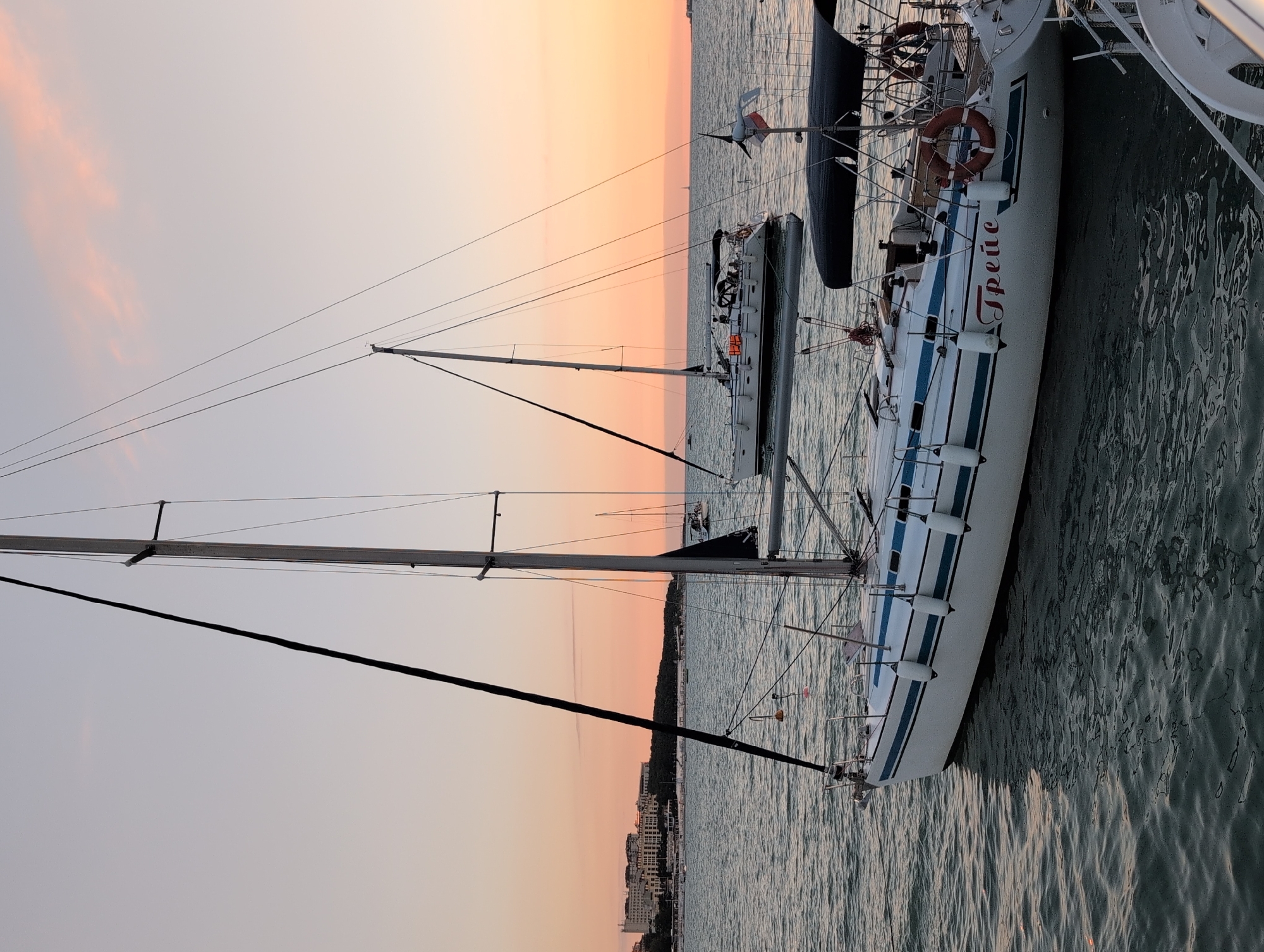 Sunset harbor scene in Gelendzhik with docked boats and promenade