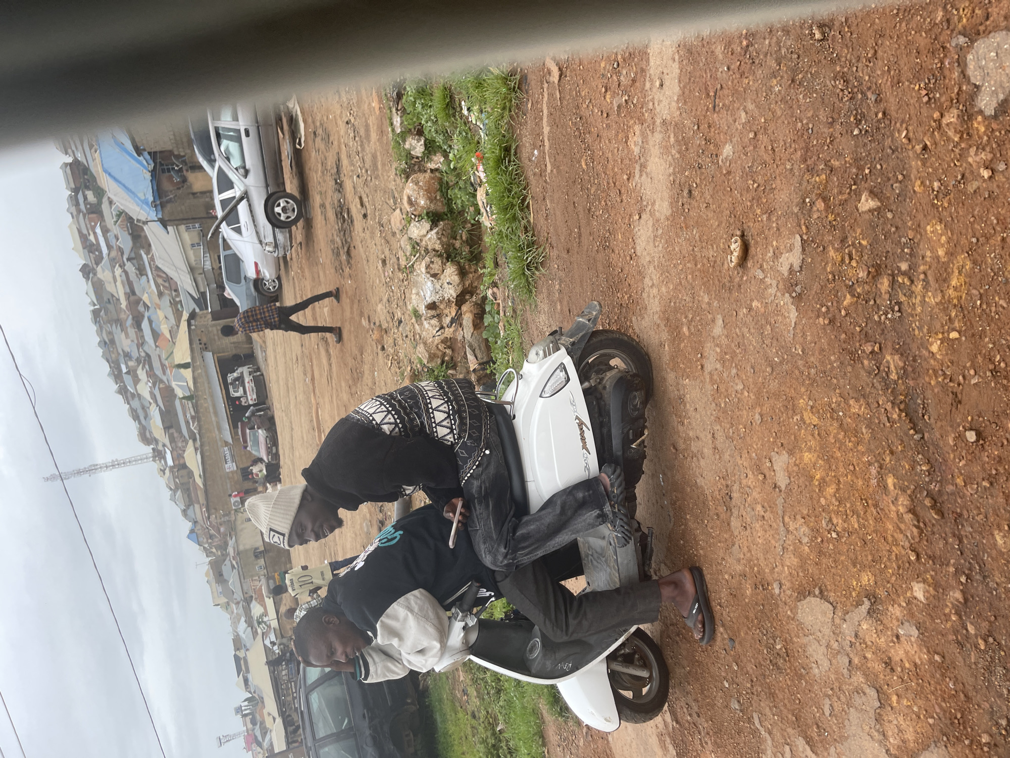 Street life and traffic along a busy Jos corridor